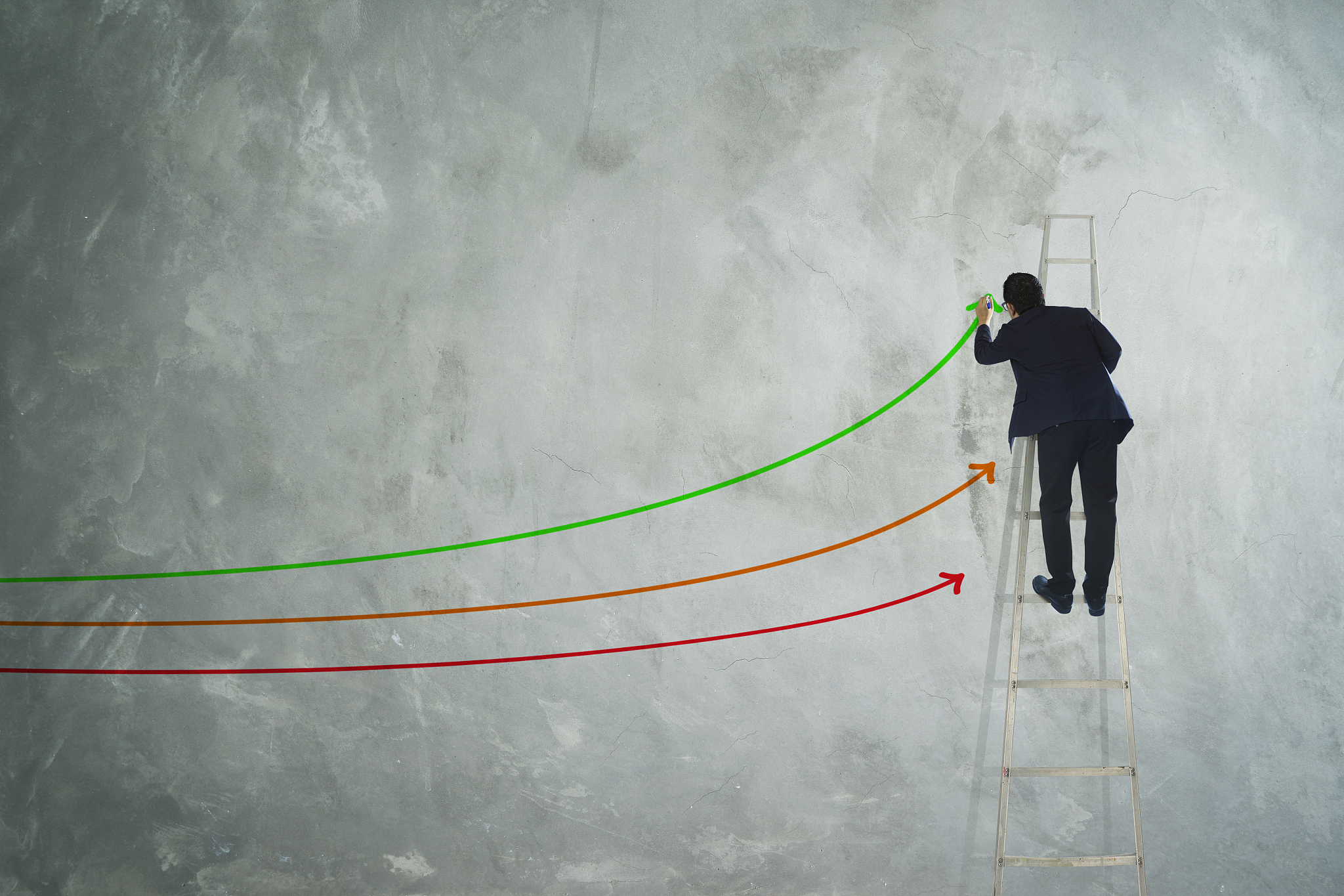 men drawing three arrow direction on grey wall .