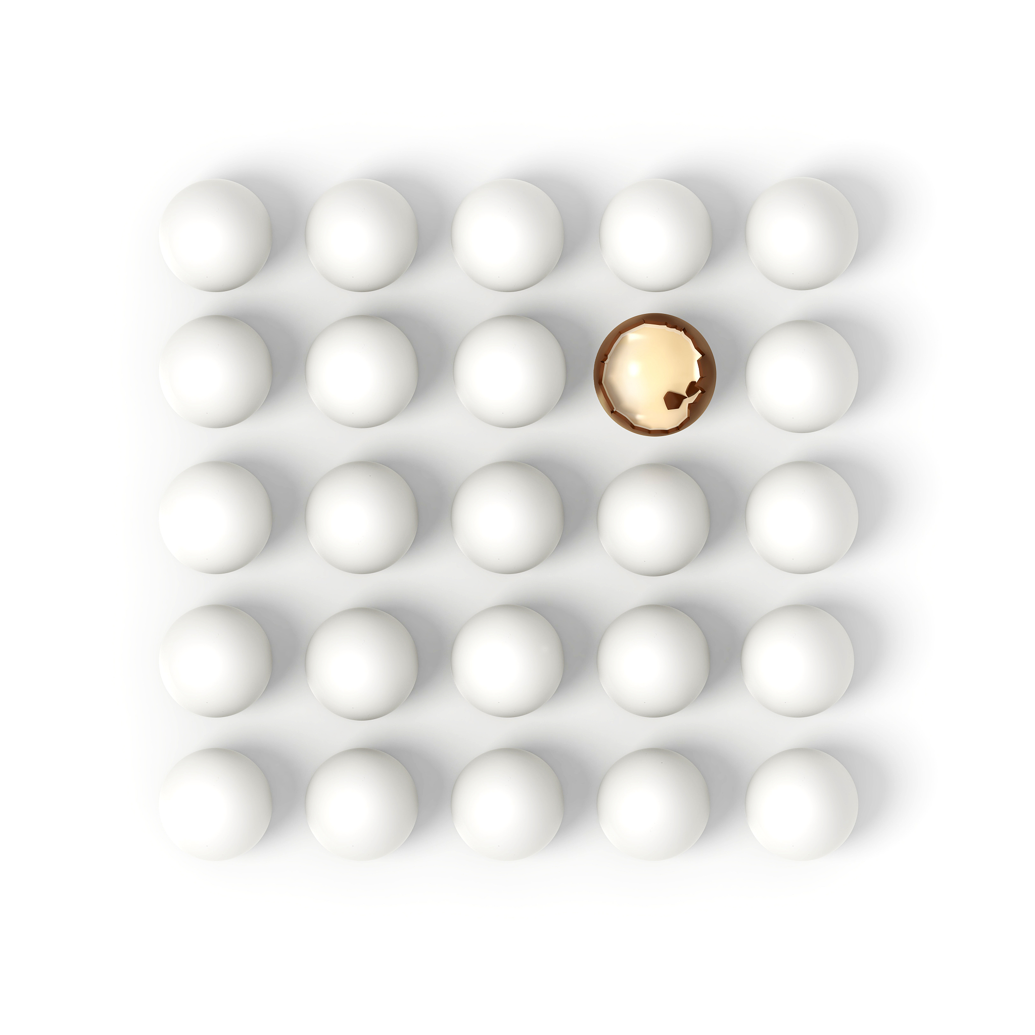 broken chocolate egg in rows of white eggs