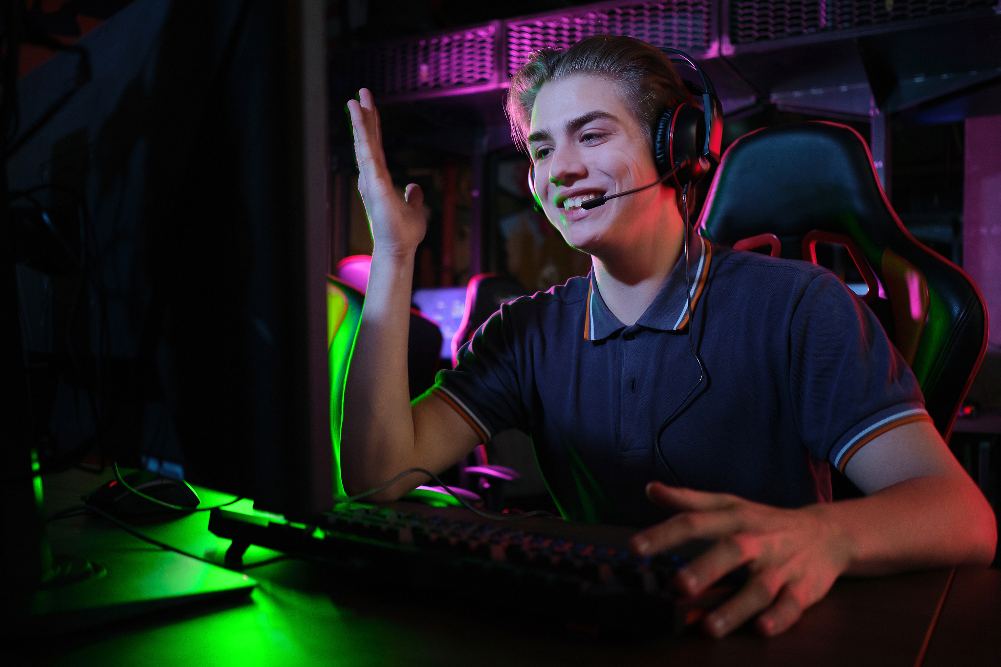 professional young caucasian gamer playing online on his pc. he 