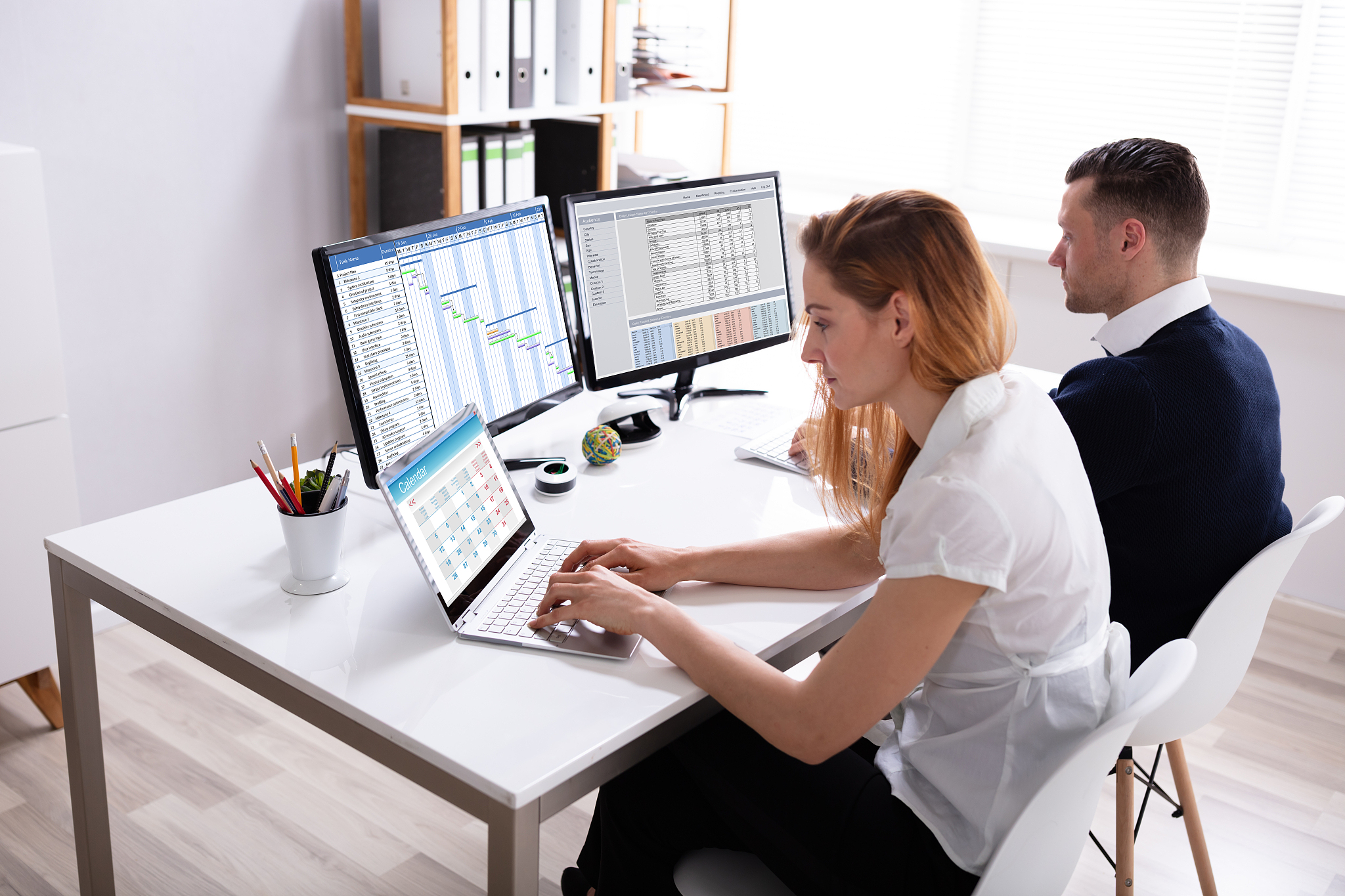 two businesspeople working in office