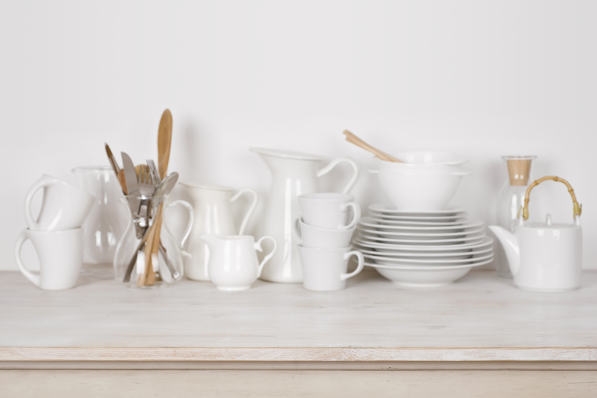 blurred kitchen dishware background on wooden table with copy sp