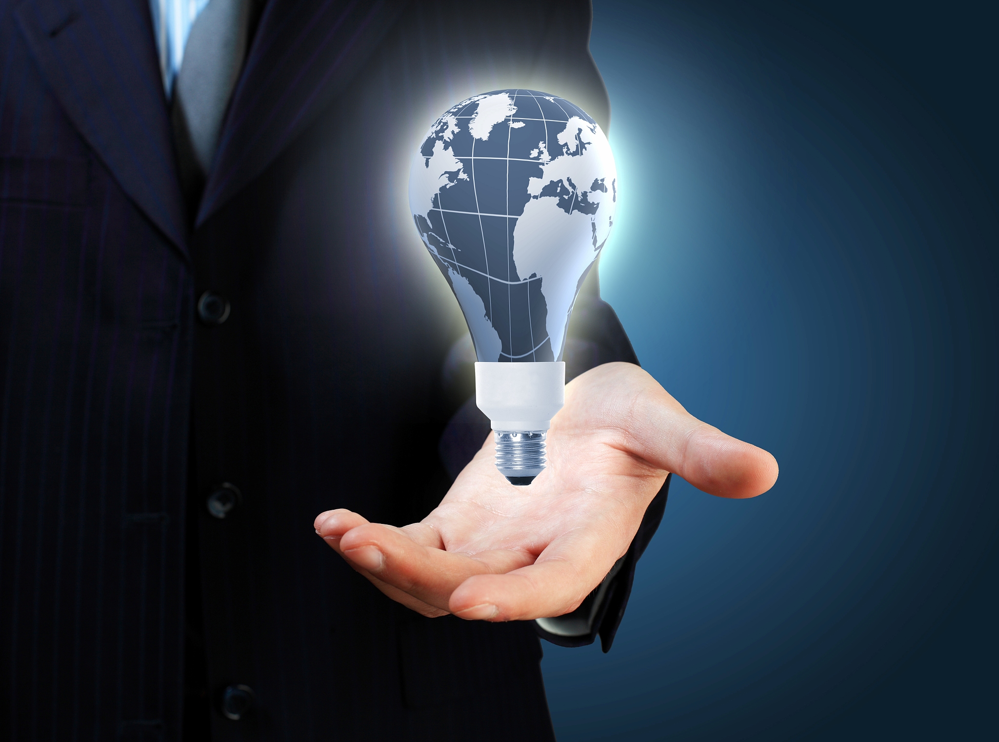 hand with lamp and hands of a business person