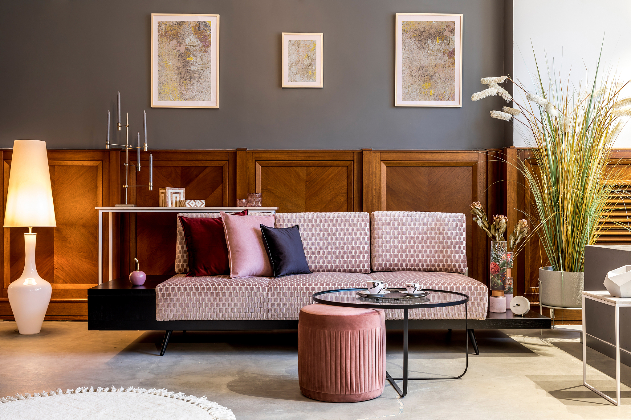 stylish interior of living room with design pink sofa, elegant p