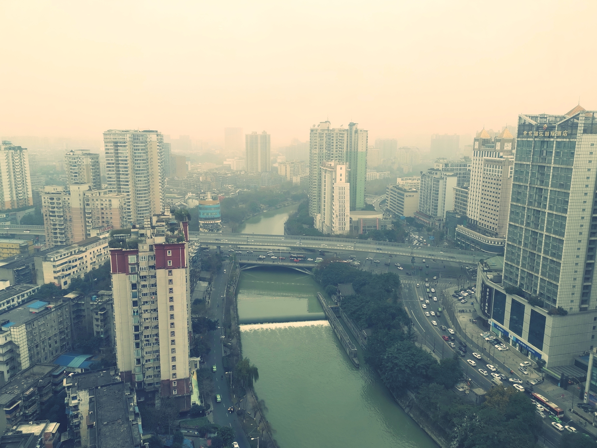 high angle view of river amidst buildings in city against sky