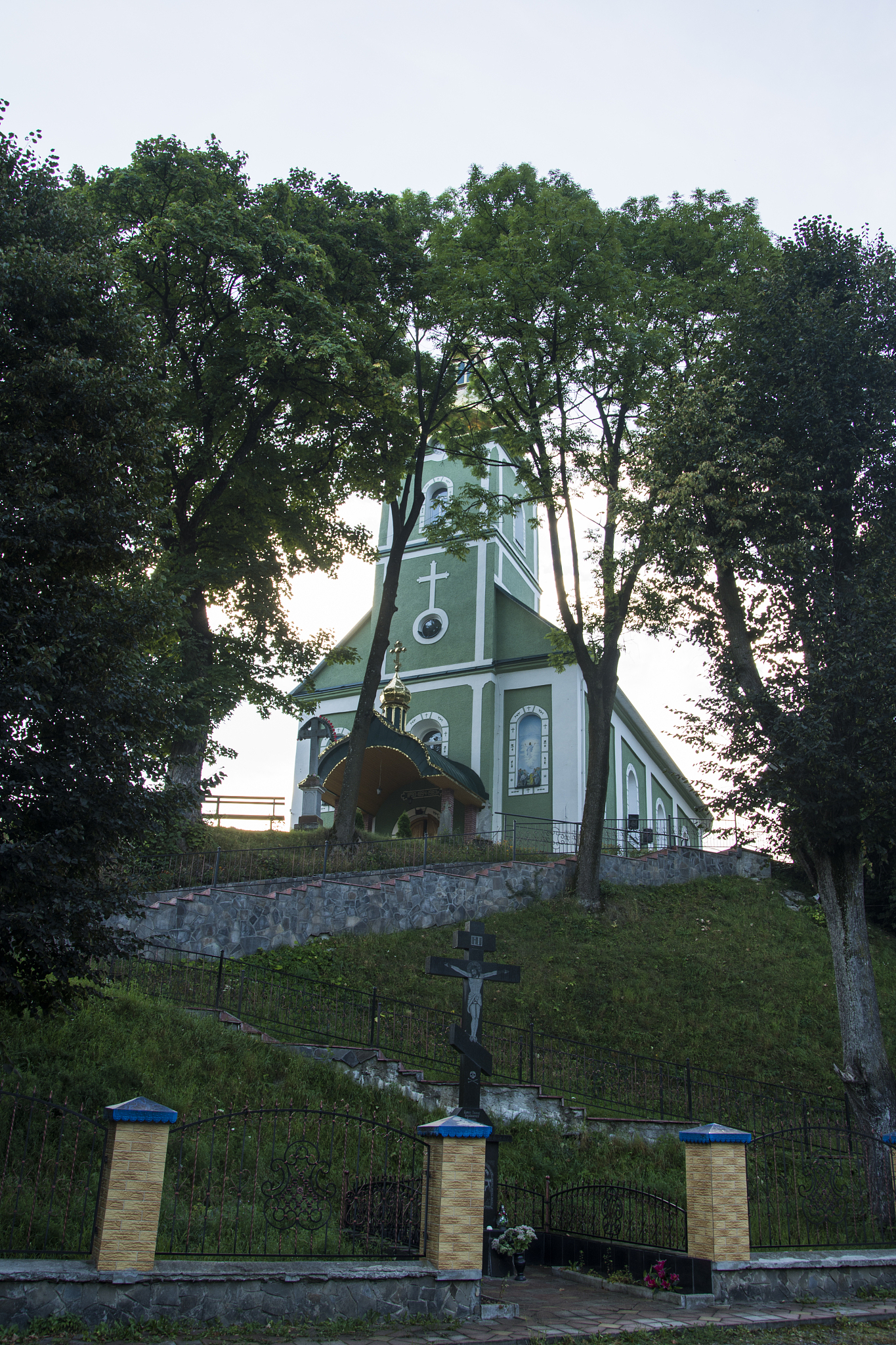 old church on a hill on the background of trees.