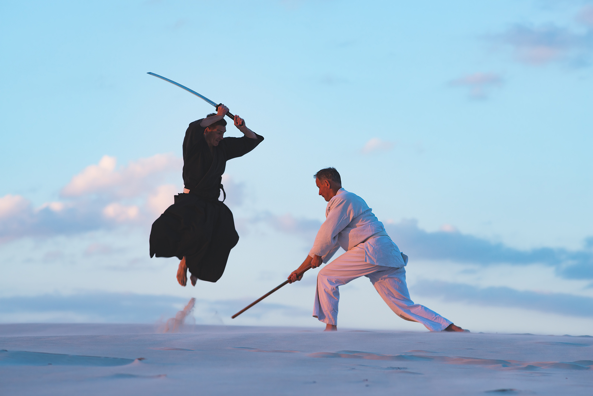 concentrated men, in japanese clothes, are practicing martial ar