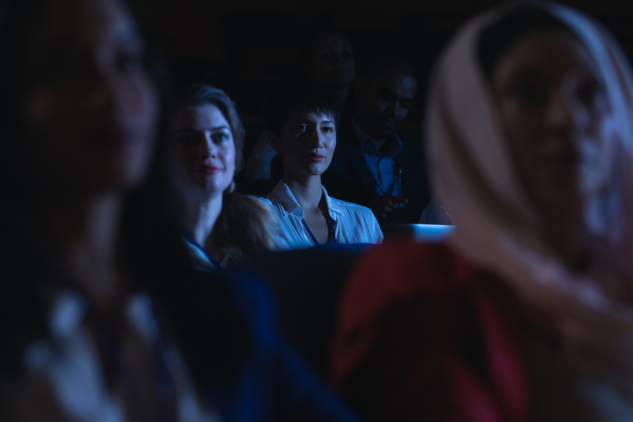 businesswoman holding laptop and listening to the presentation i
