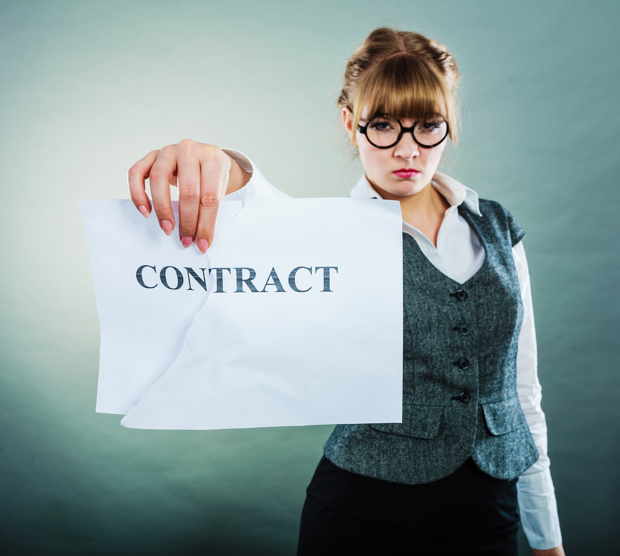 unhappy business woman showing crumpled contract