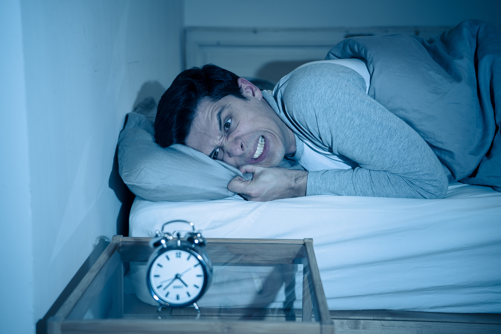 sleepless and desperate young man awake at night not able to sle