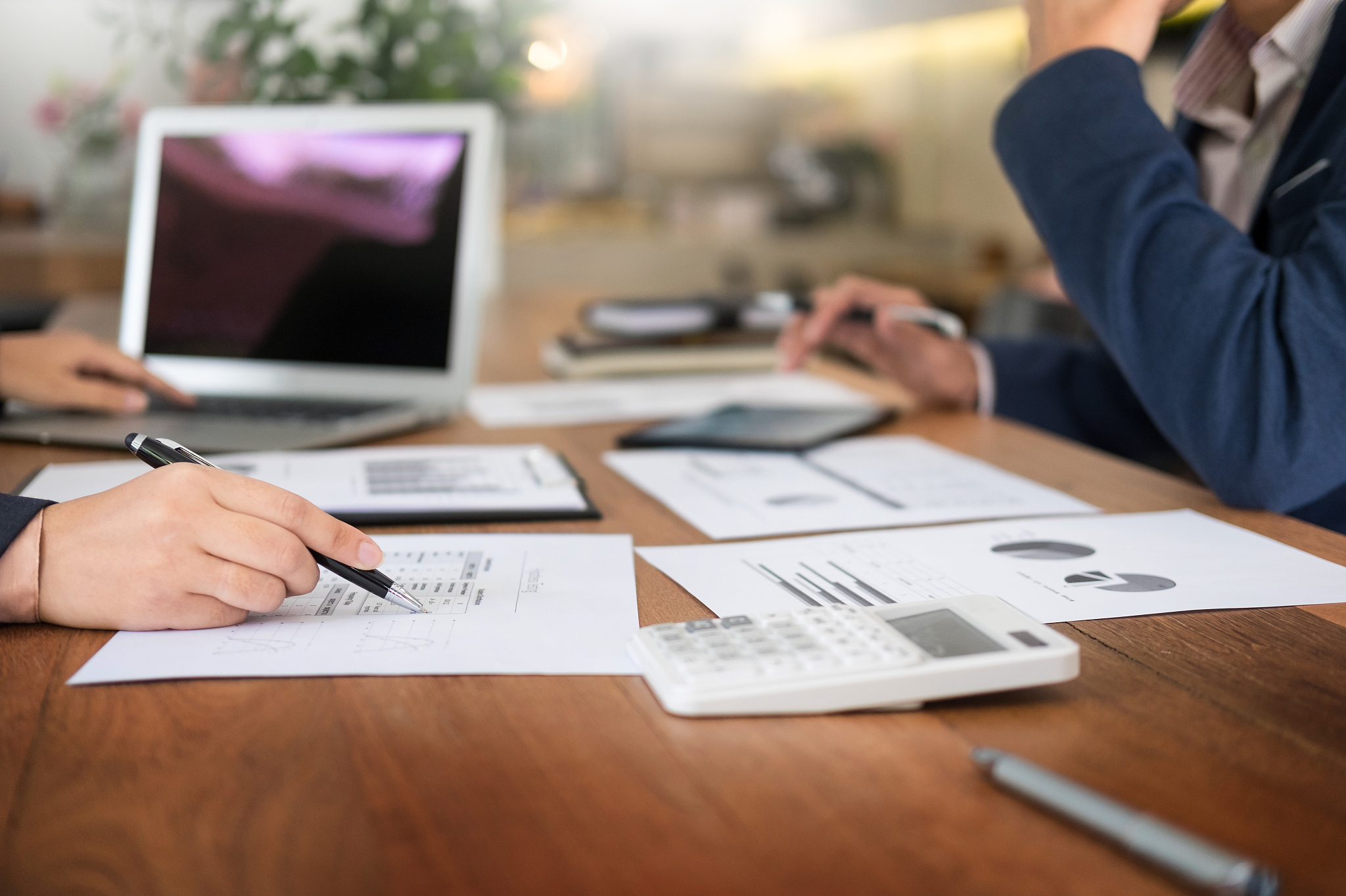 cropped image of business people working on document in office