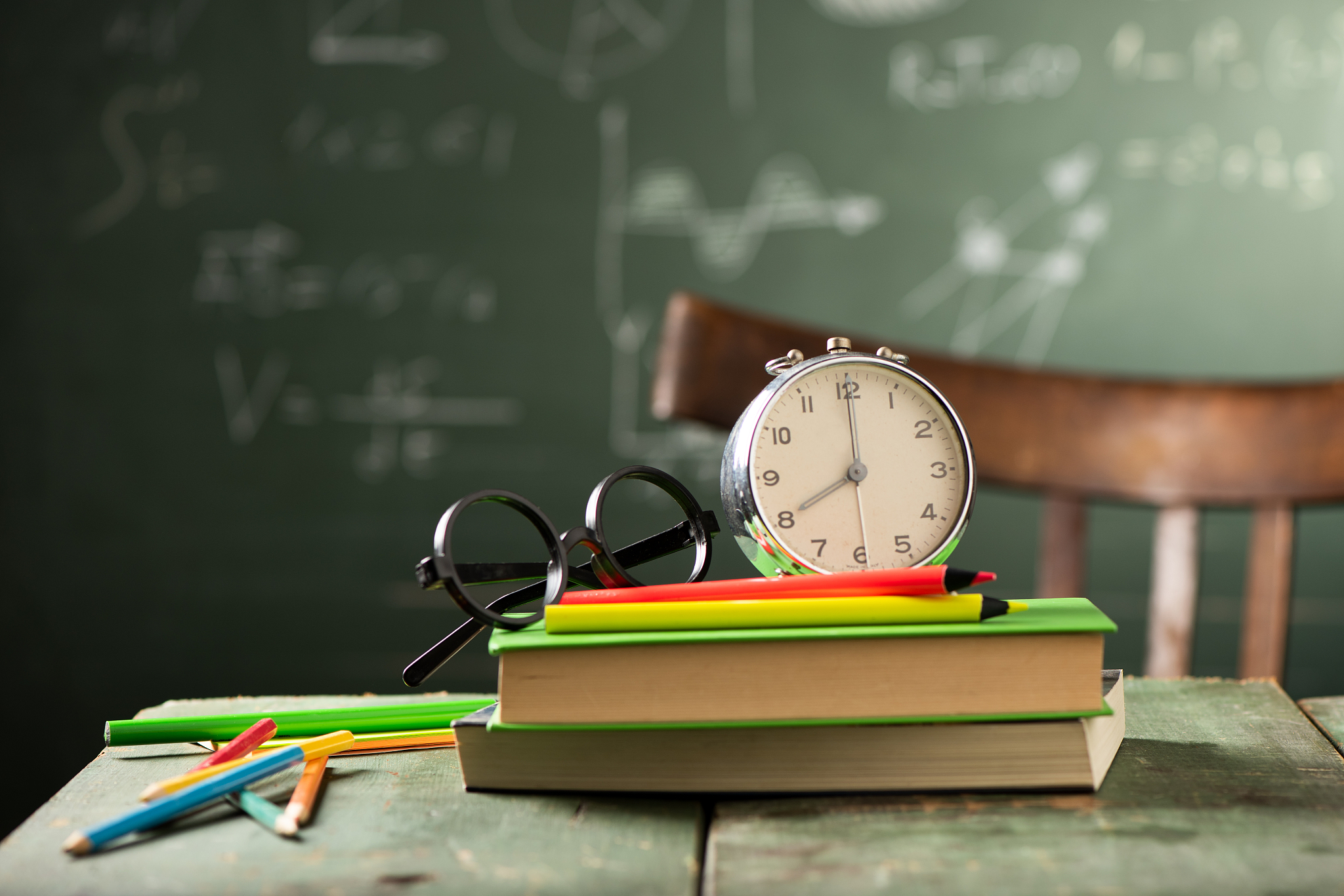 back to school background with books and alarm clock