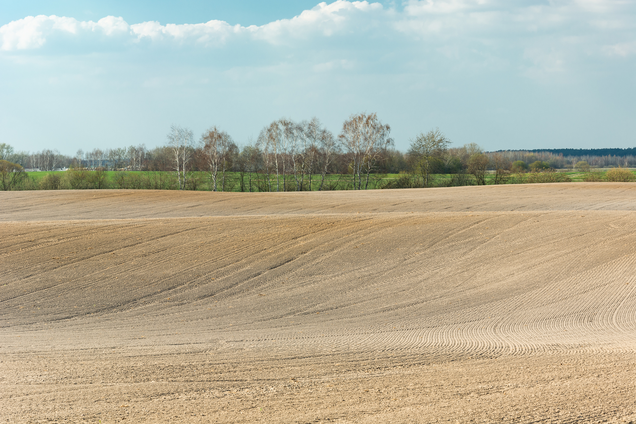 ploughed and leveled field in the hills, spring view