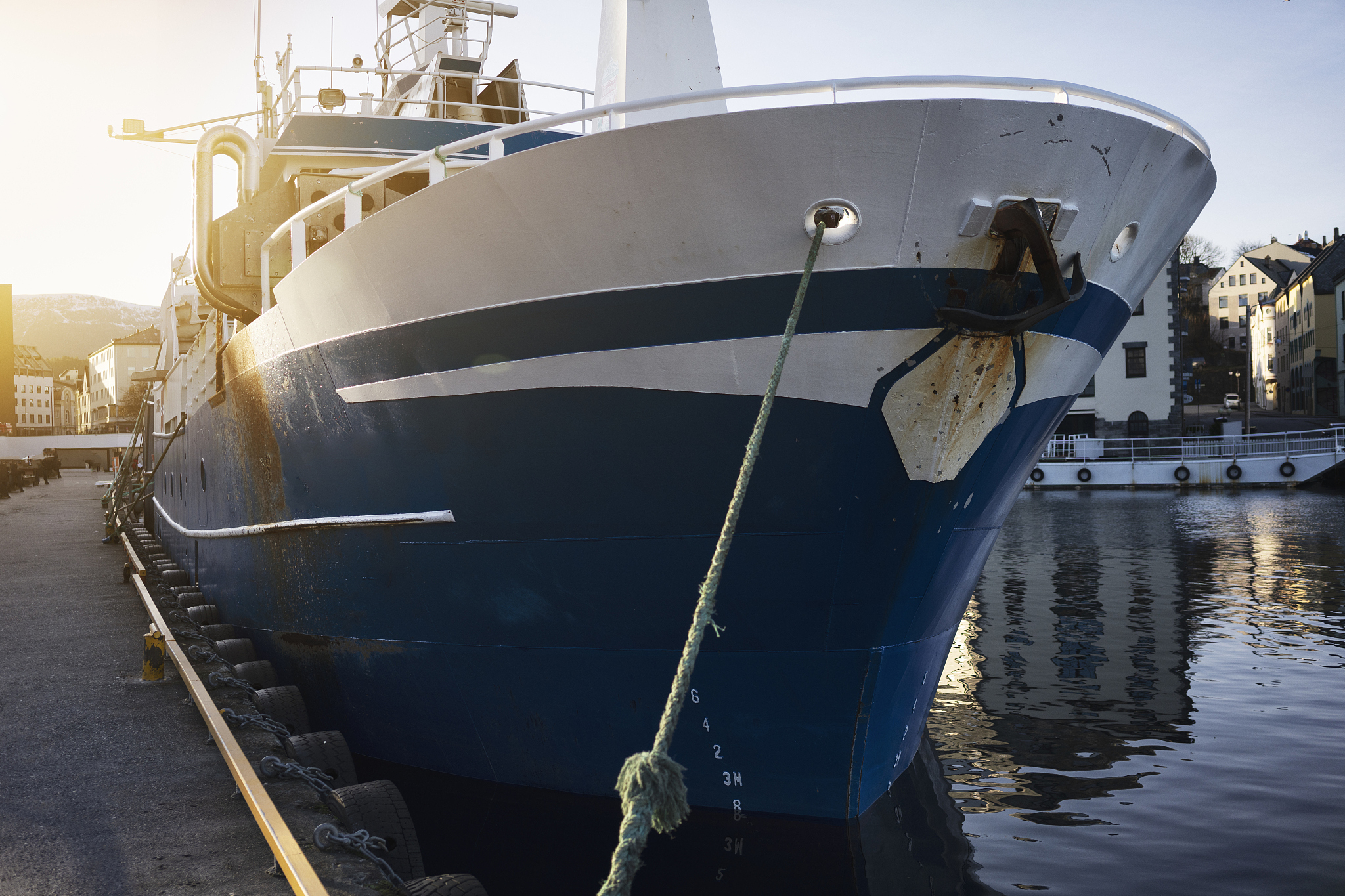 fishing boat at the harbor of alesund, norway