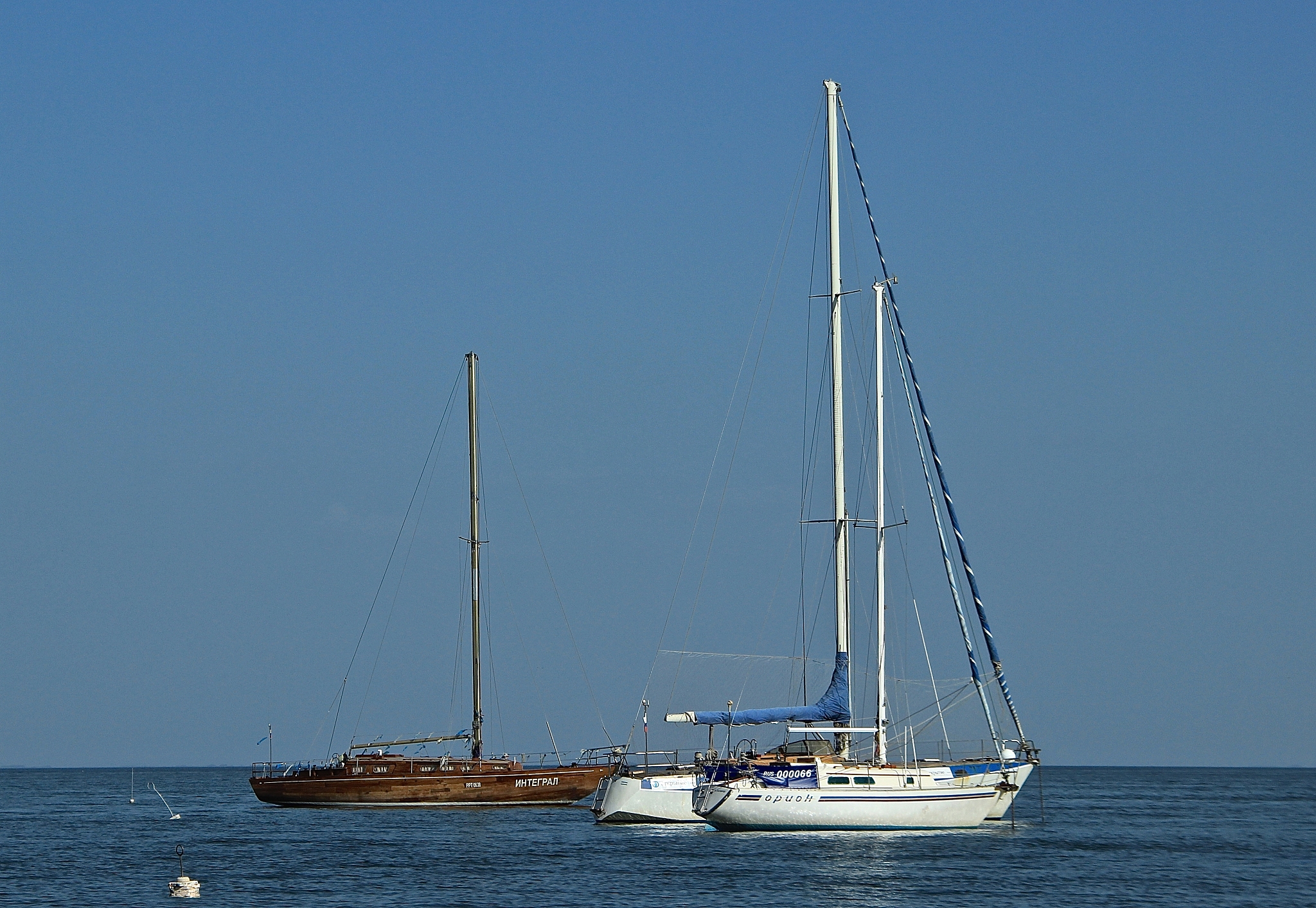 sailboat sailing on sea against clear blue sky