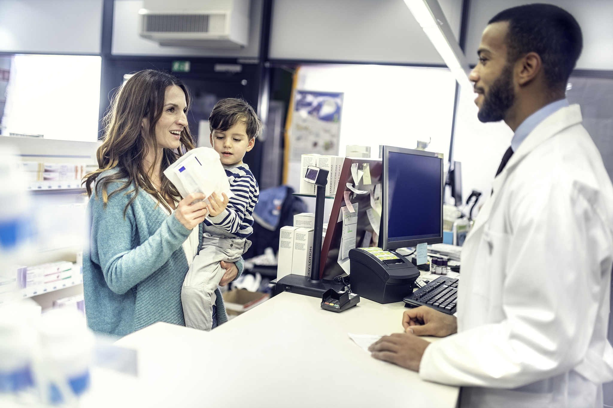 customer talking with pharmacist in drugstore