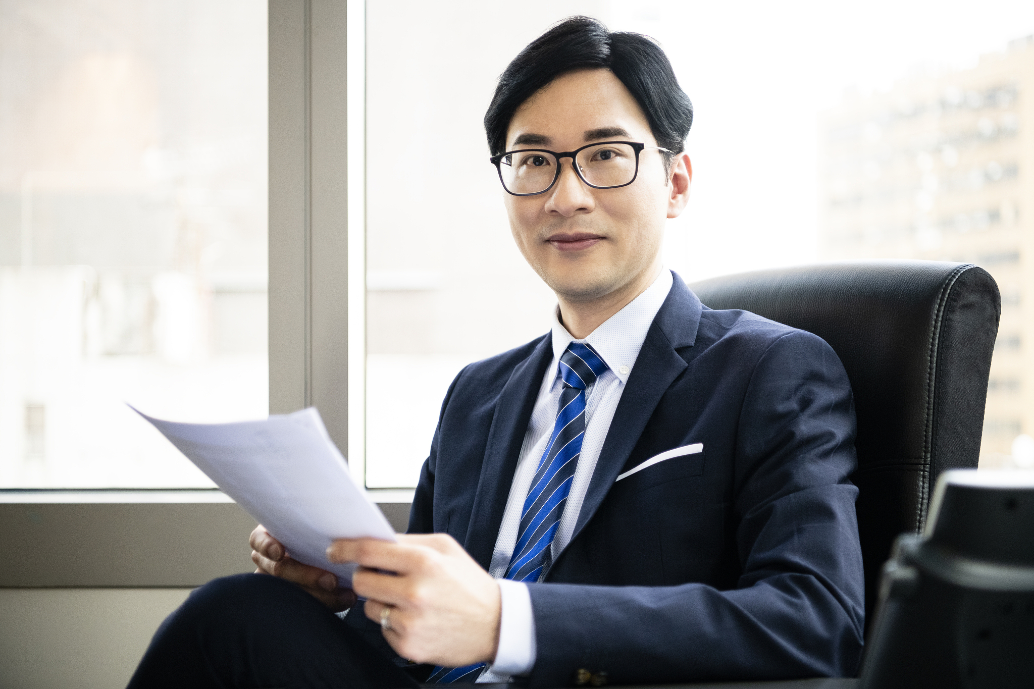 chinese business professional in office with paperwork