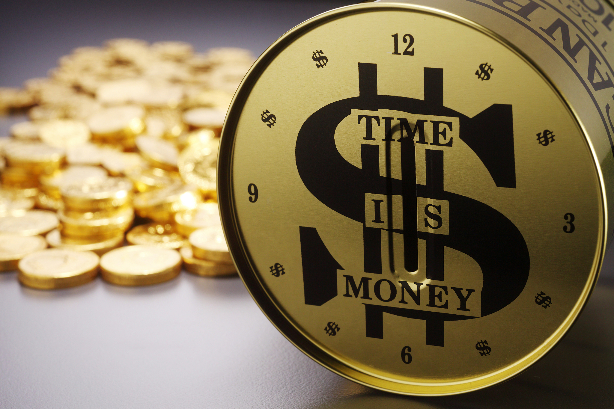 close-up of coin bank with currency against gray background