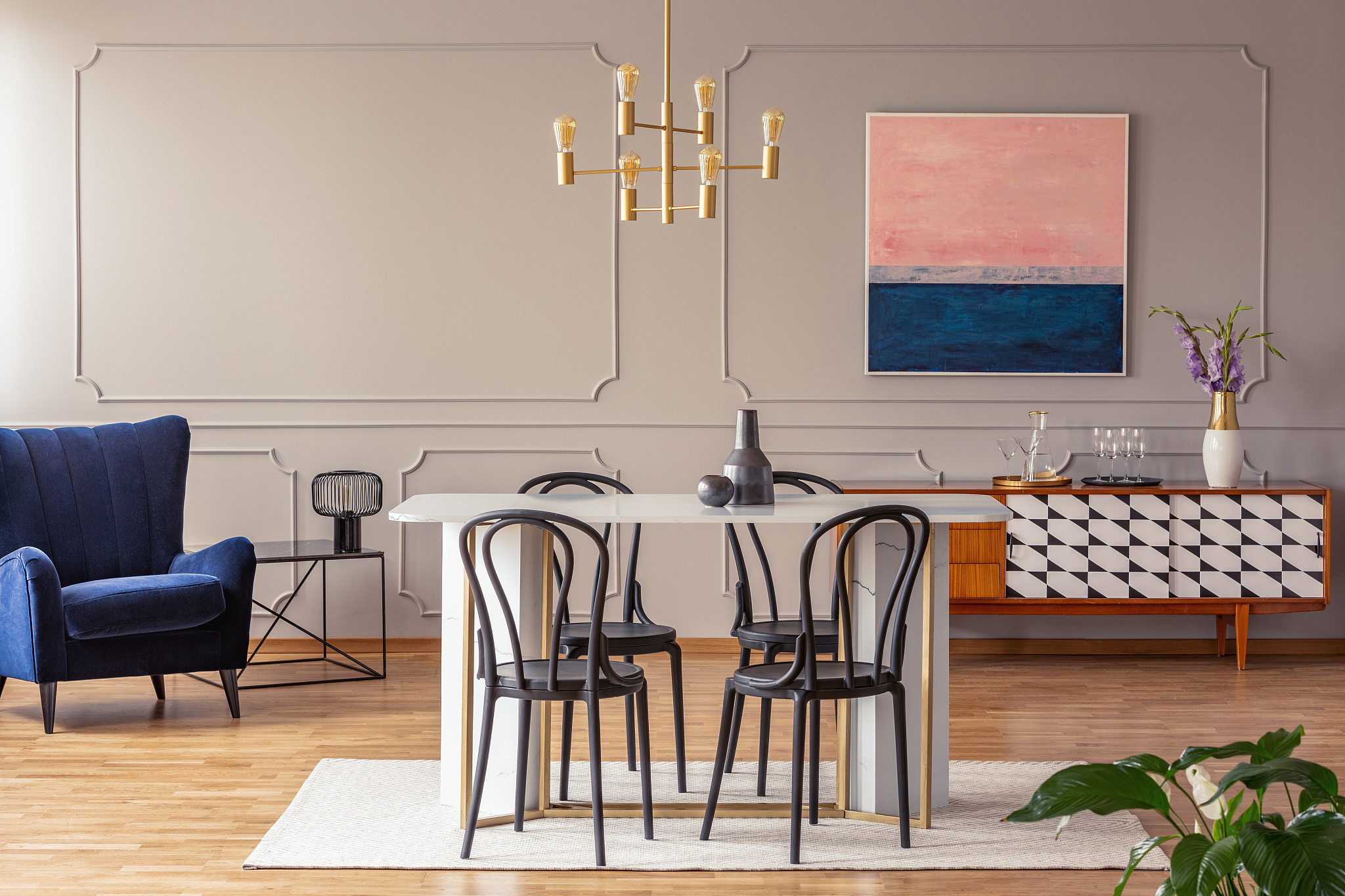 pink and navy blue abstract painting on a gray wall with molding