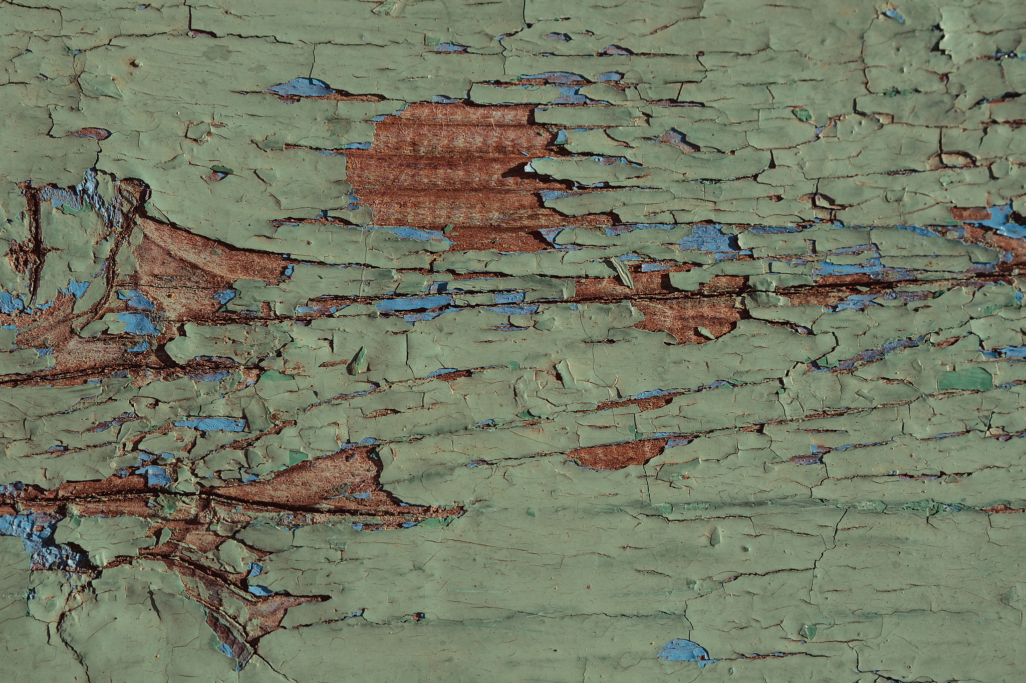 texture of wood painted green board with cracks and scratches