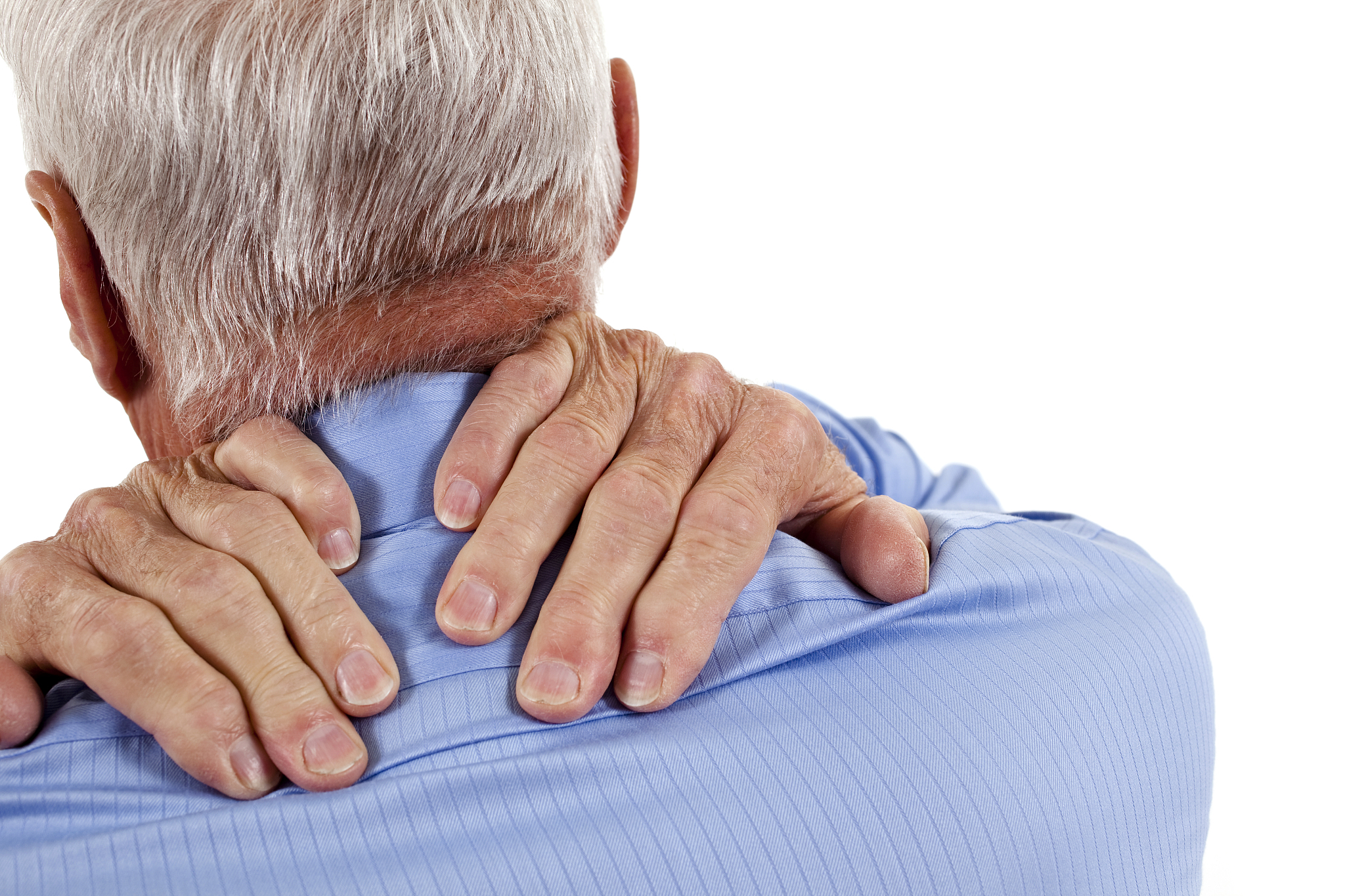 senior man with hands rubbing shoulders and neck in pain