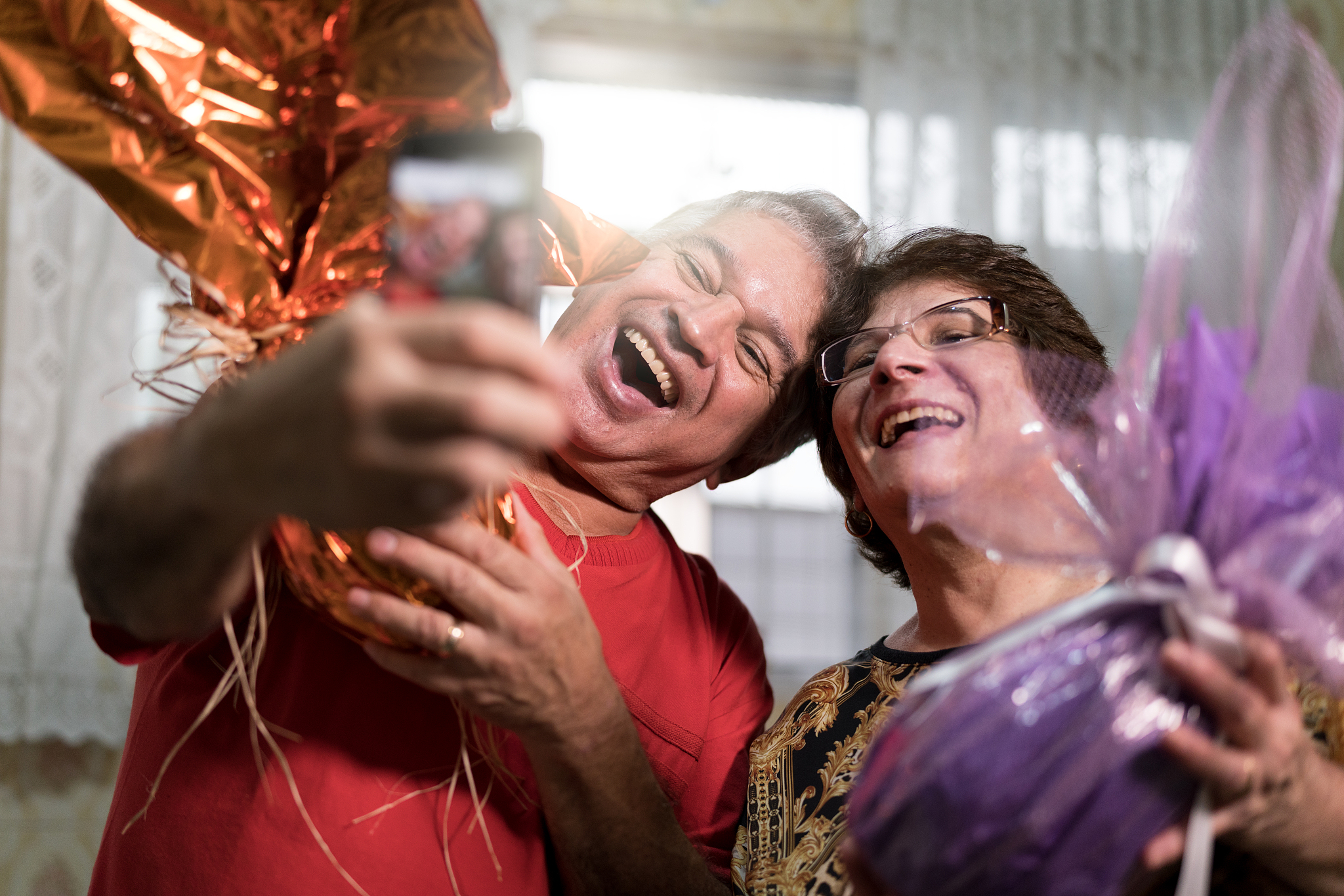 senior couple celebrating the brazilian easter with chocolate eg
