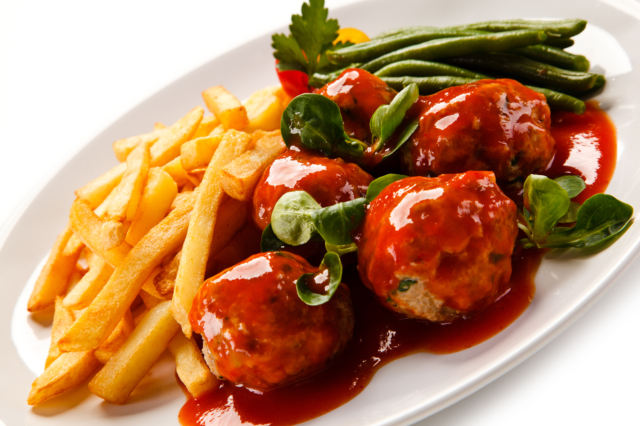 roast meatballs, baked potatoes and green beans on white backgro