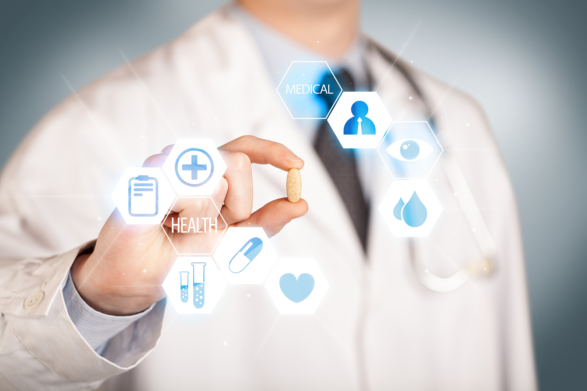 a doctor in white holding a pill