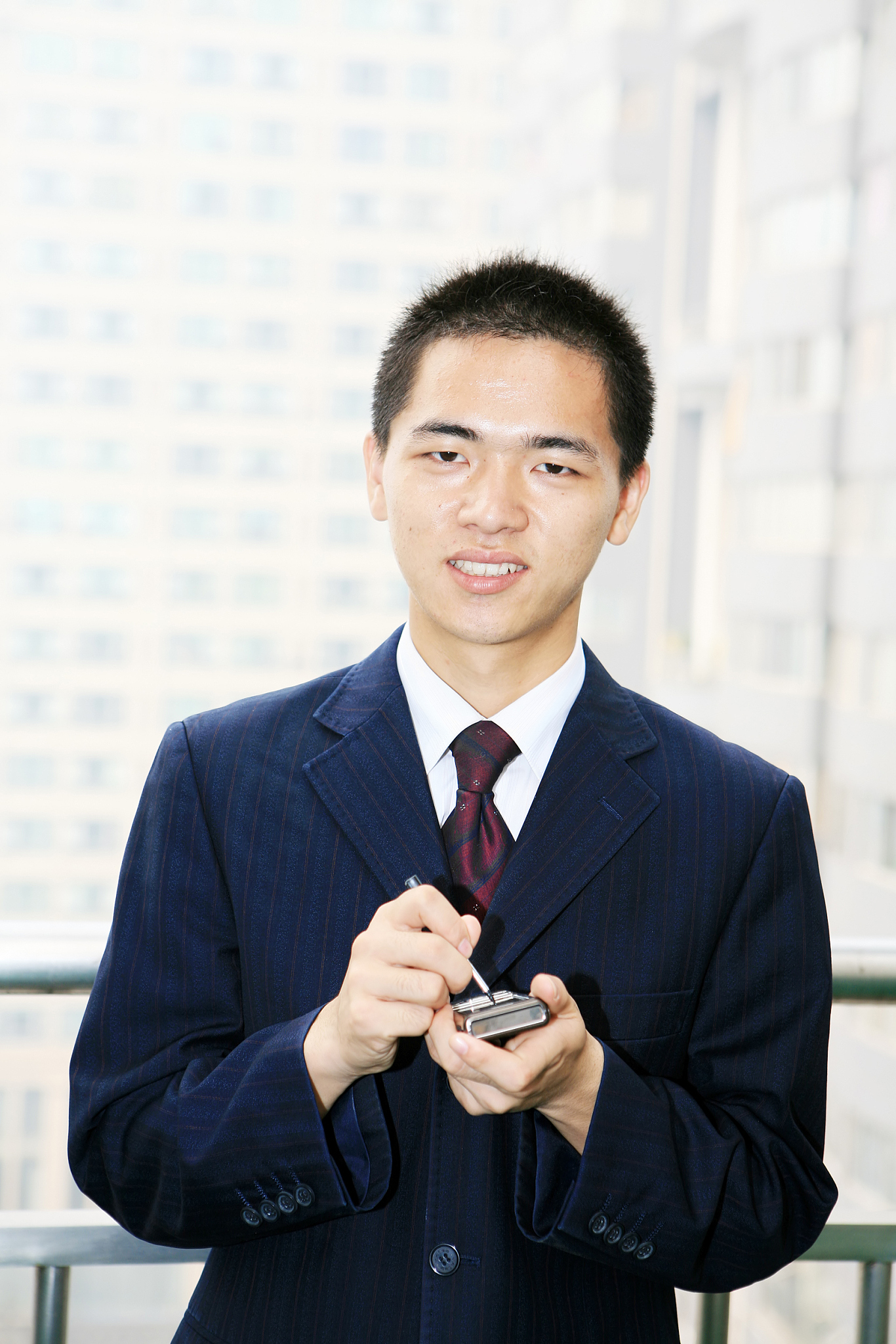 young businessman holding mobile phone