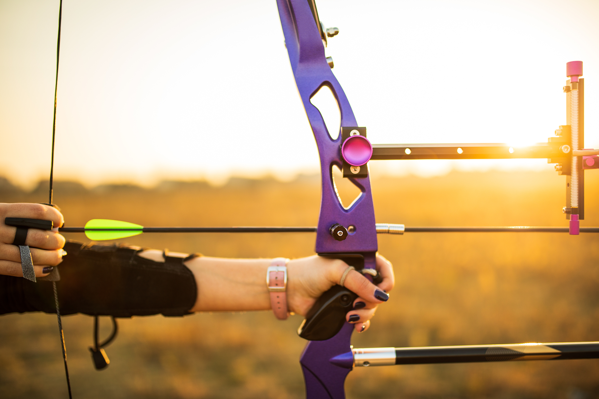 teenage girl on archery training at sunset
