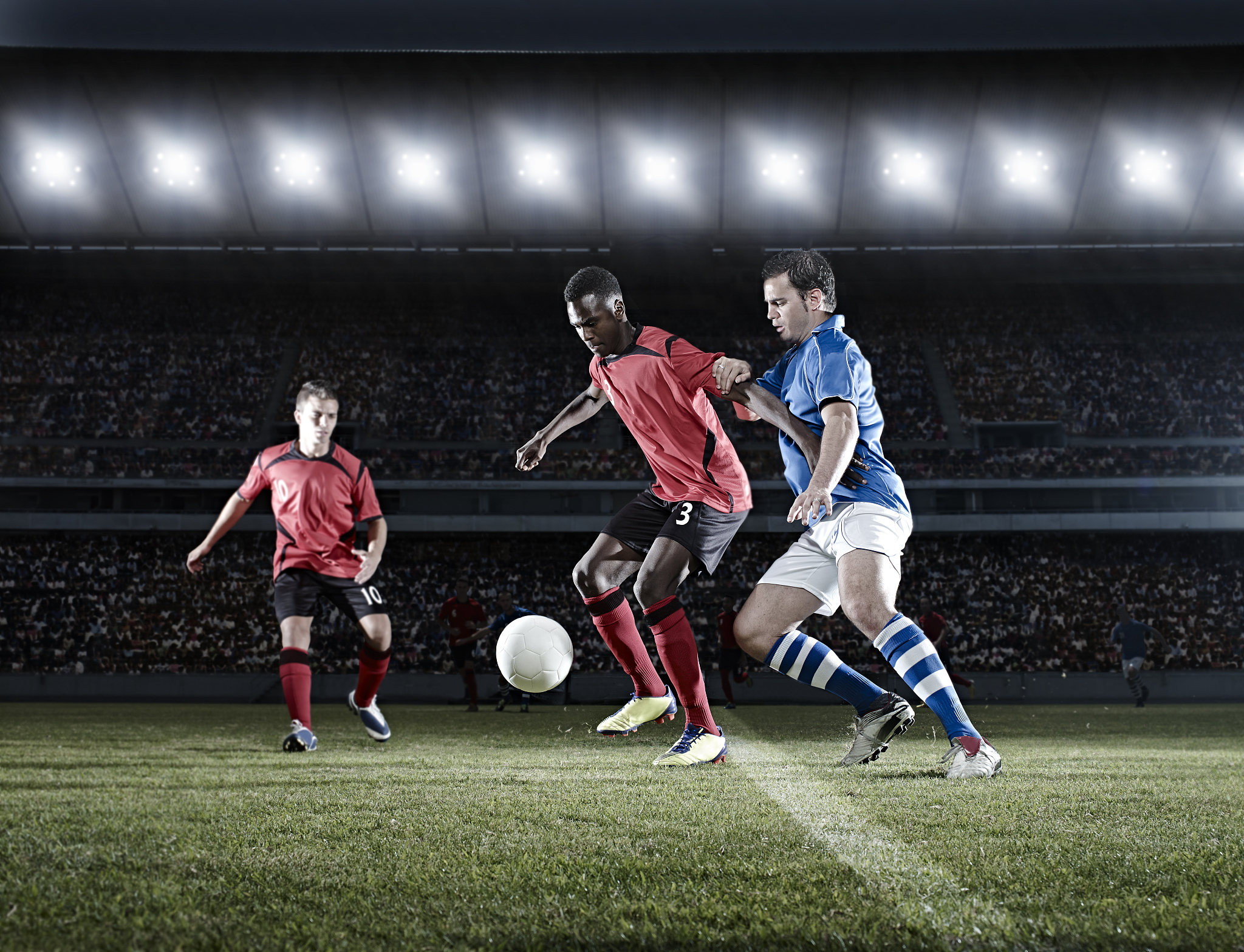 soccer players with ball on field