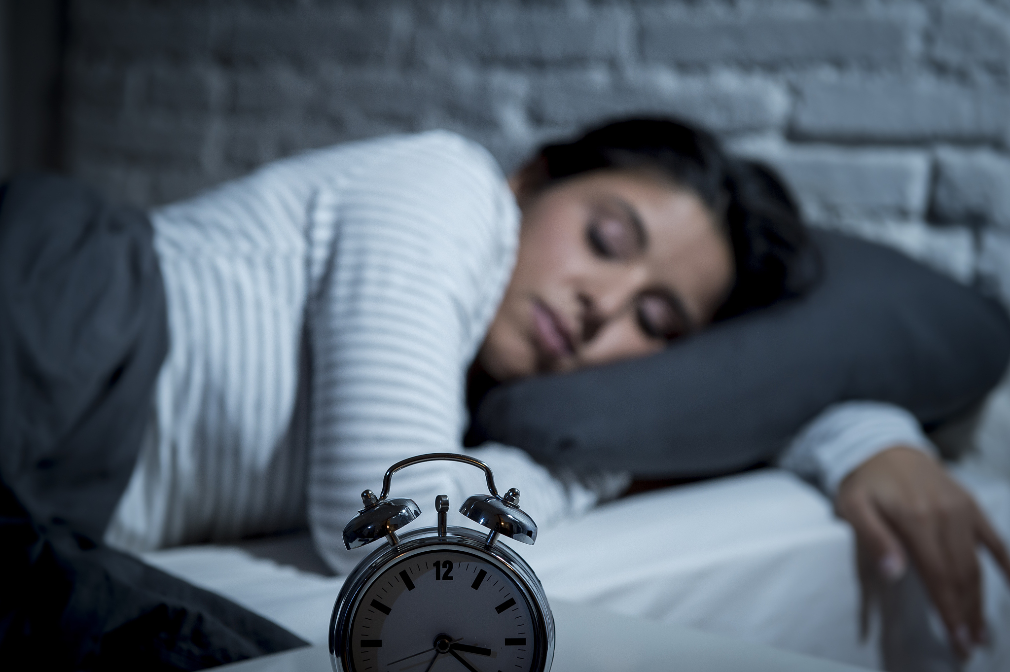 woman in bed late night trying to sleep suffering insomnia