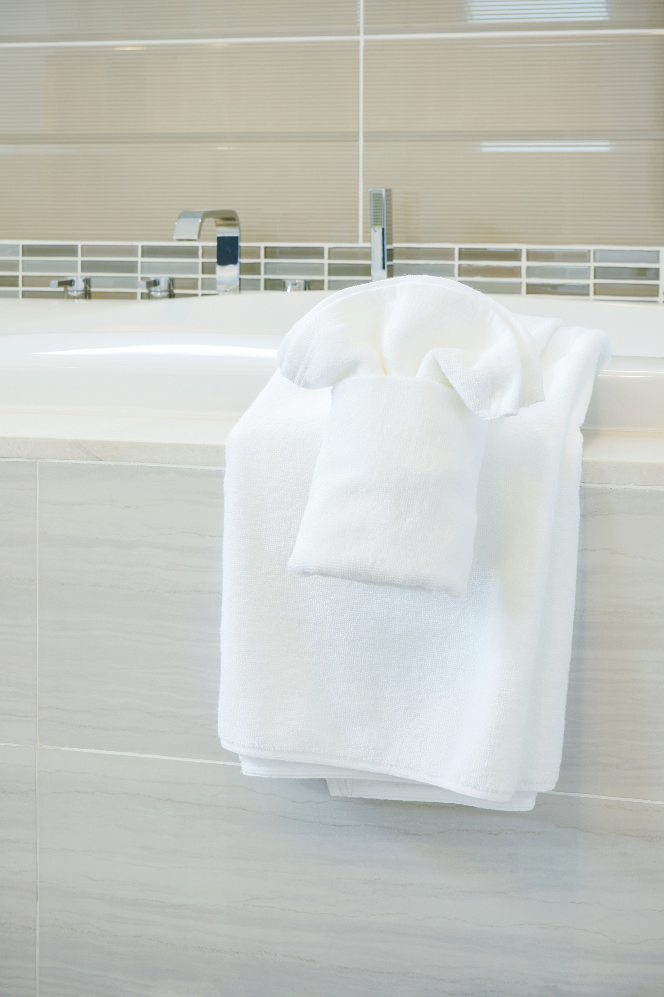 closeup bathtub with white towels in modern style bathroom