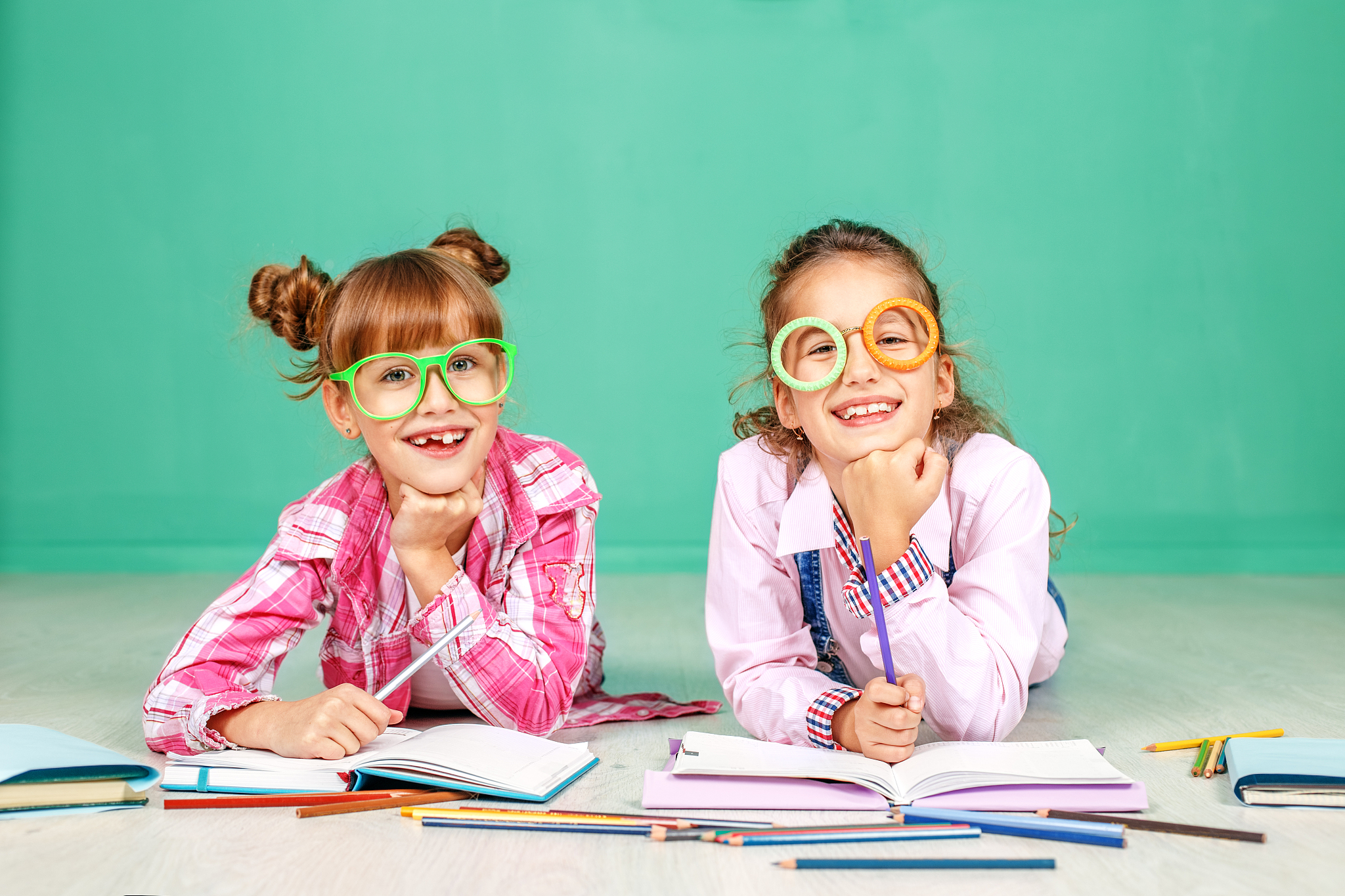 two children laugh and read in glasses. the concept of childhood