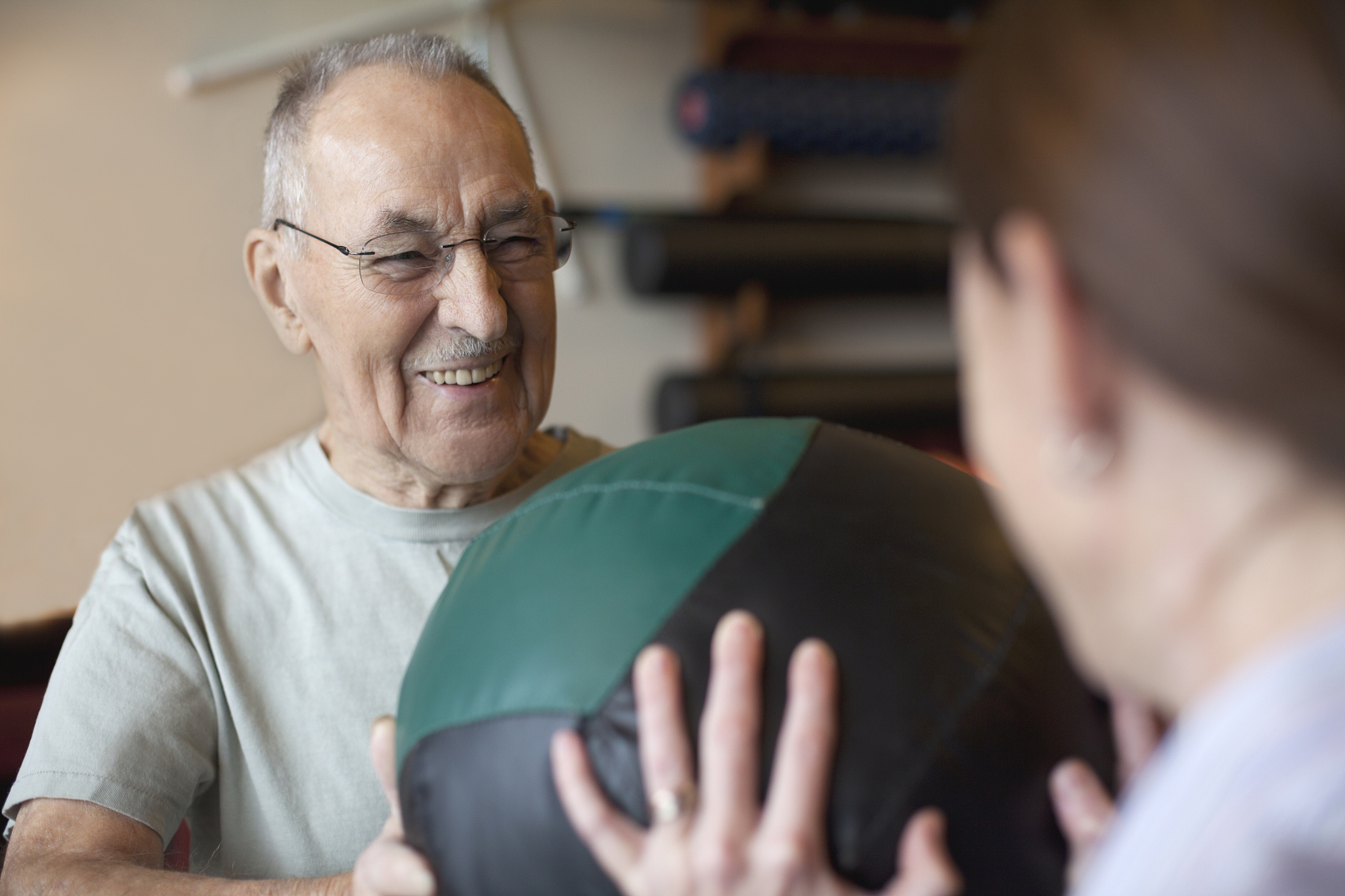 mature man exercising with physical therapist.