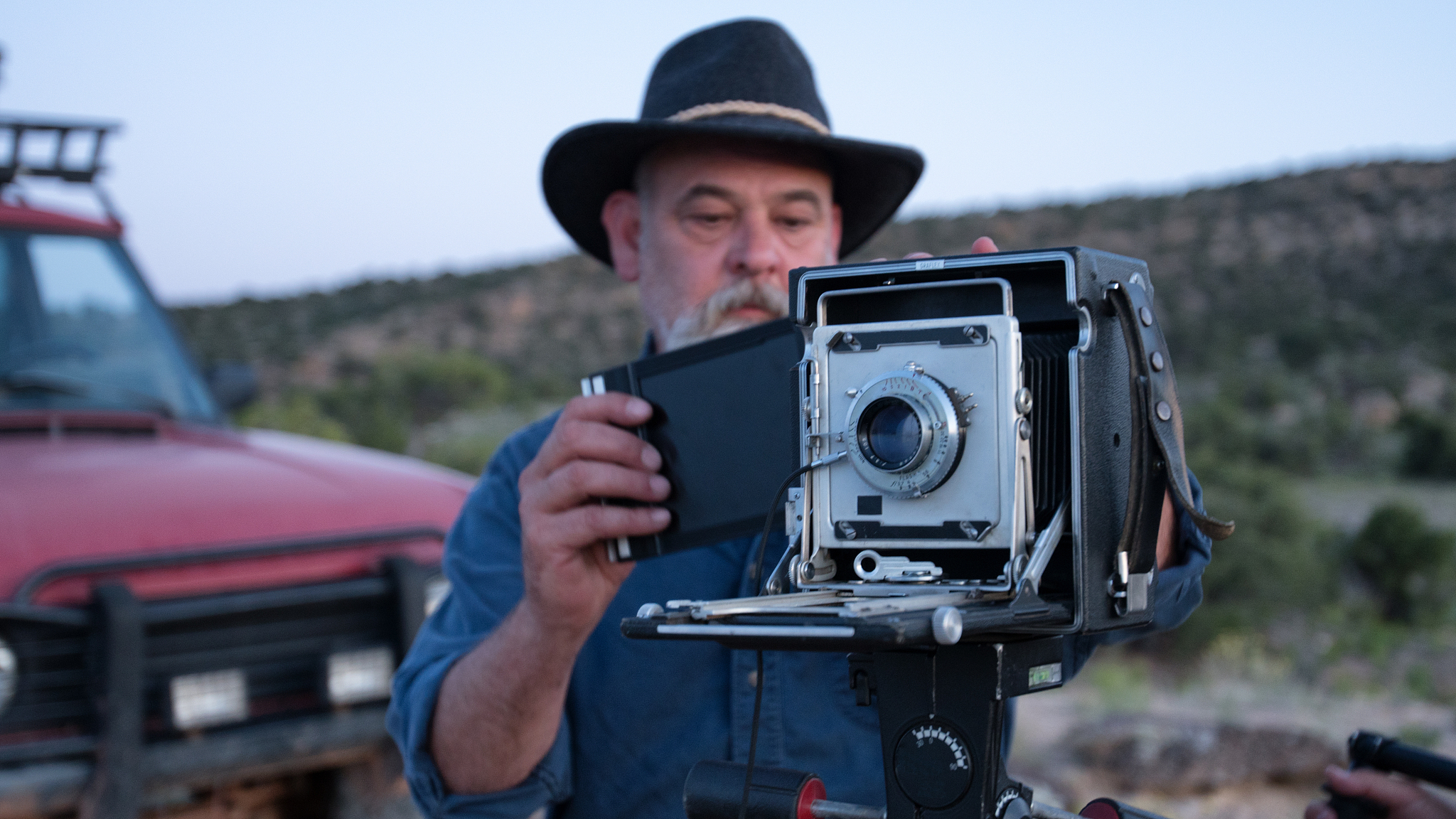 mature male photographer with medium format camera