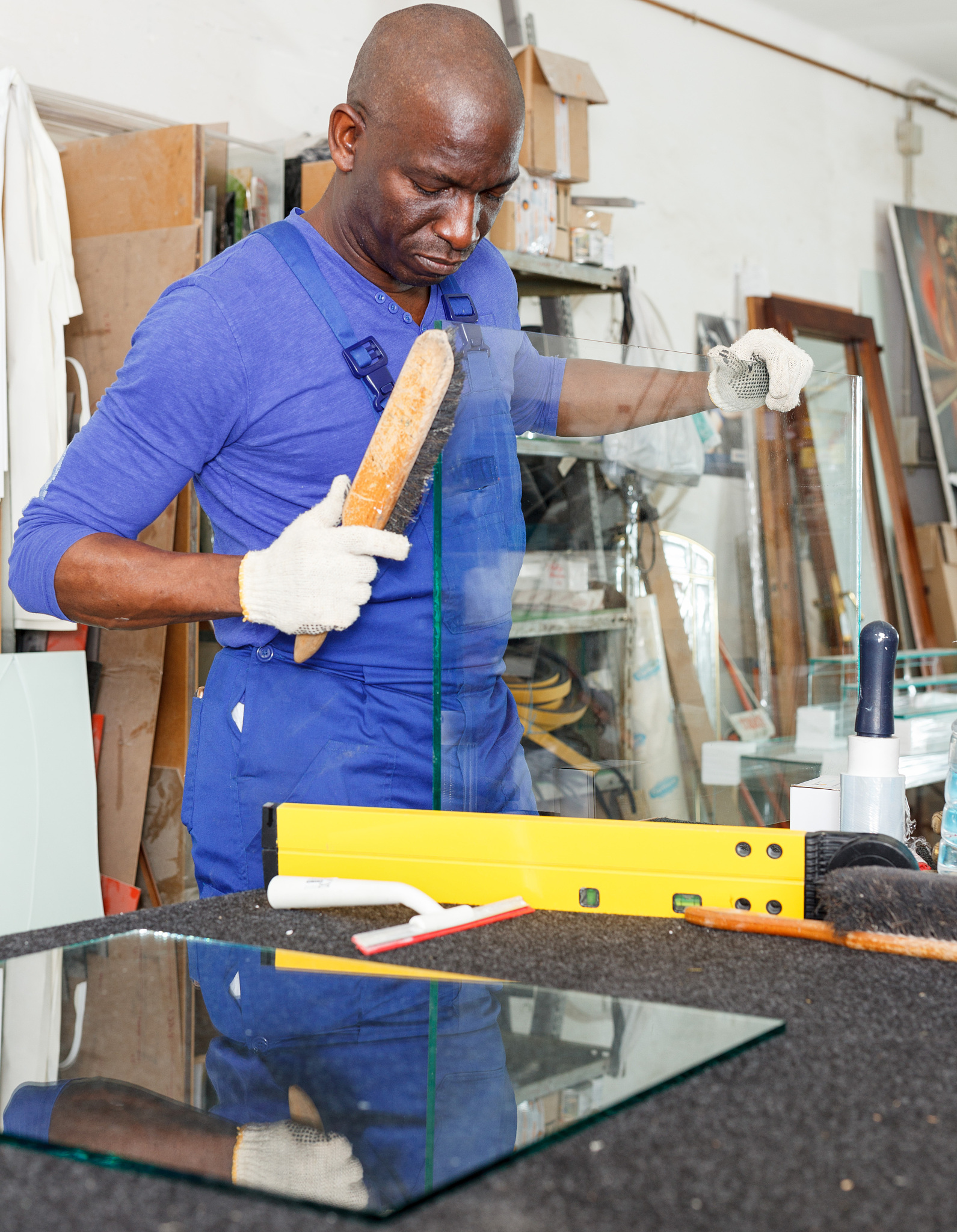 glazier working in glass factory