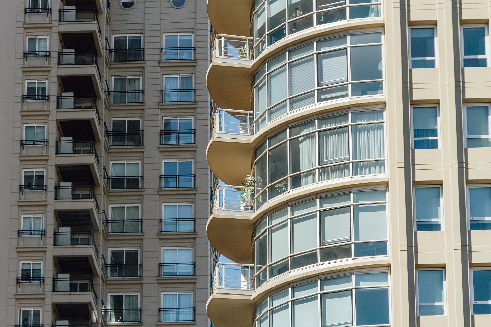 blue windows and balconies of one apartment building front anoth