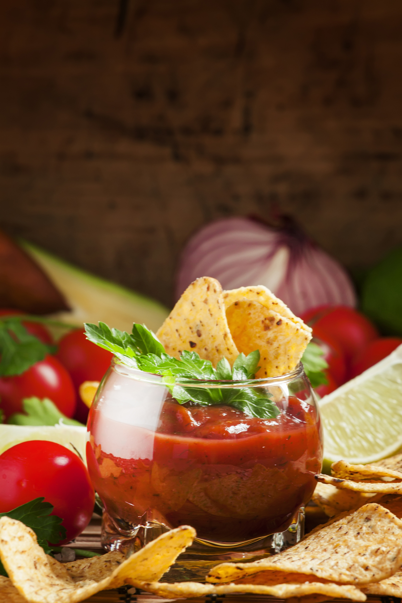 unhealthy food: mexican nachos with spicy tomato sauce and lime