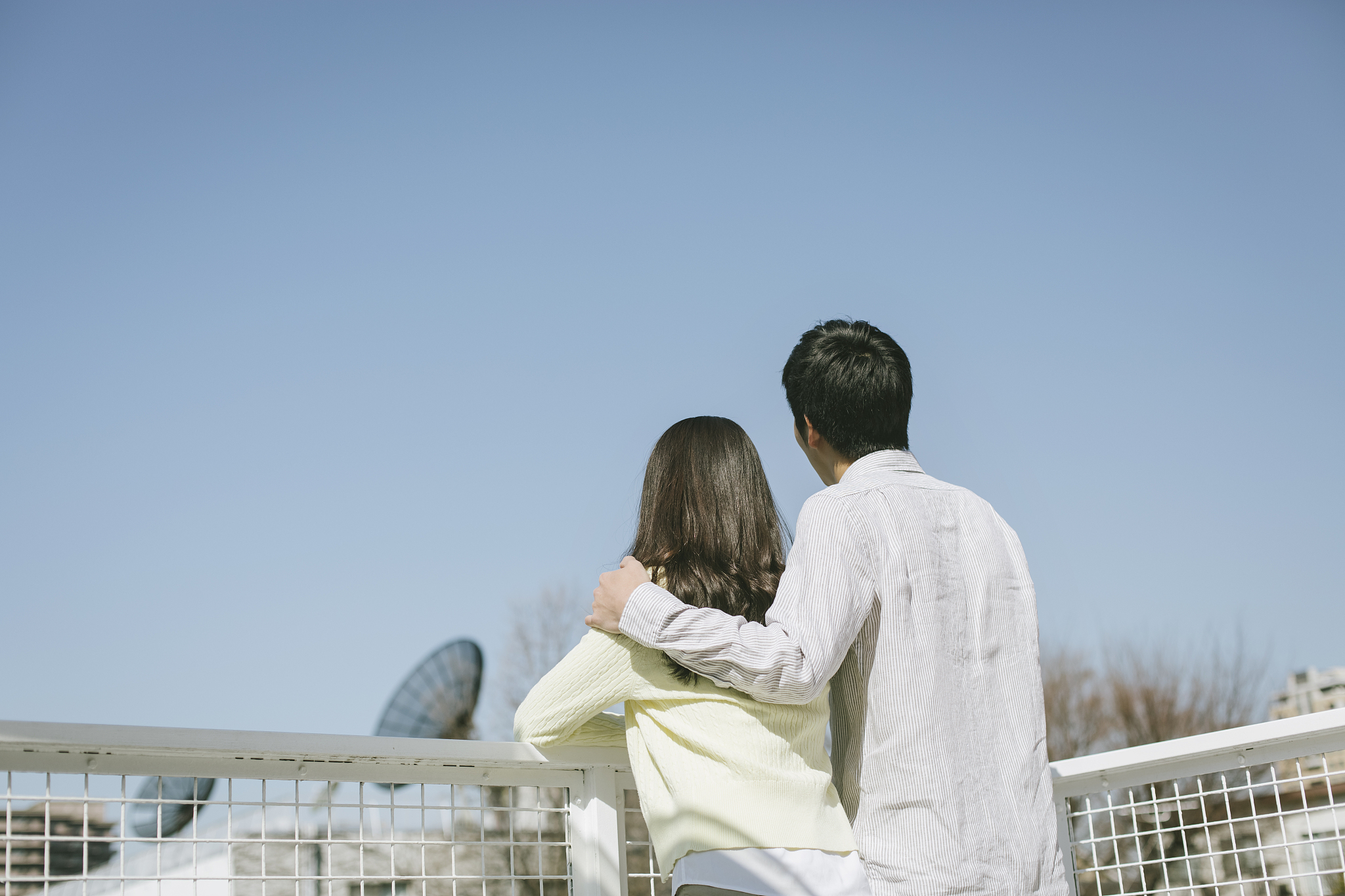 photography of couple standing outside looking the view