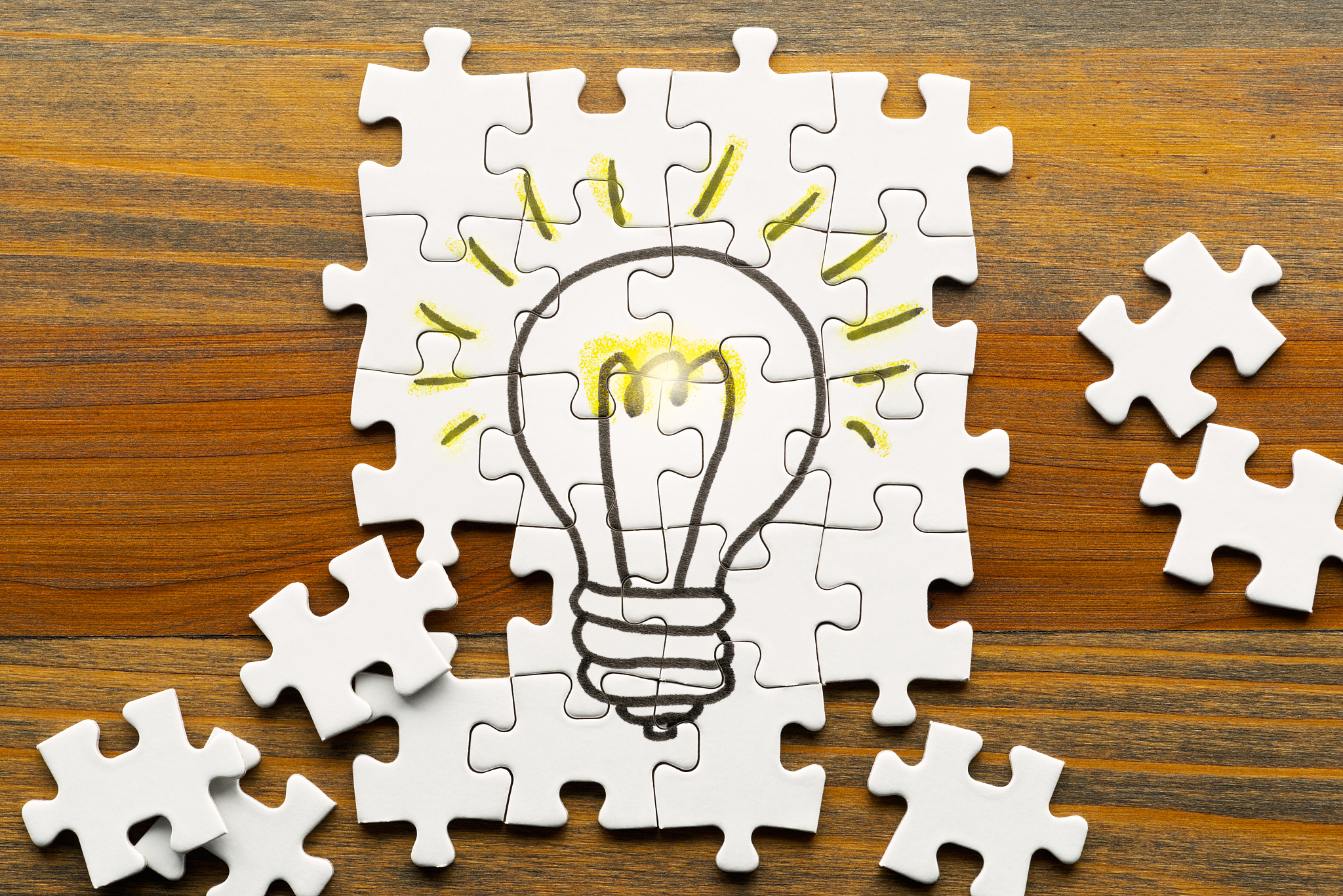 idea creation. light bulb drawn on puzzle.