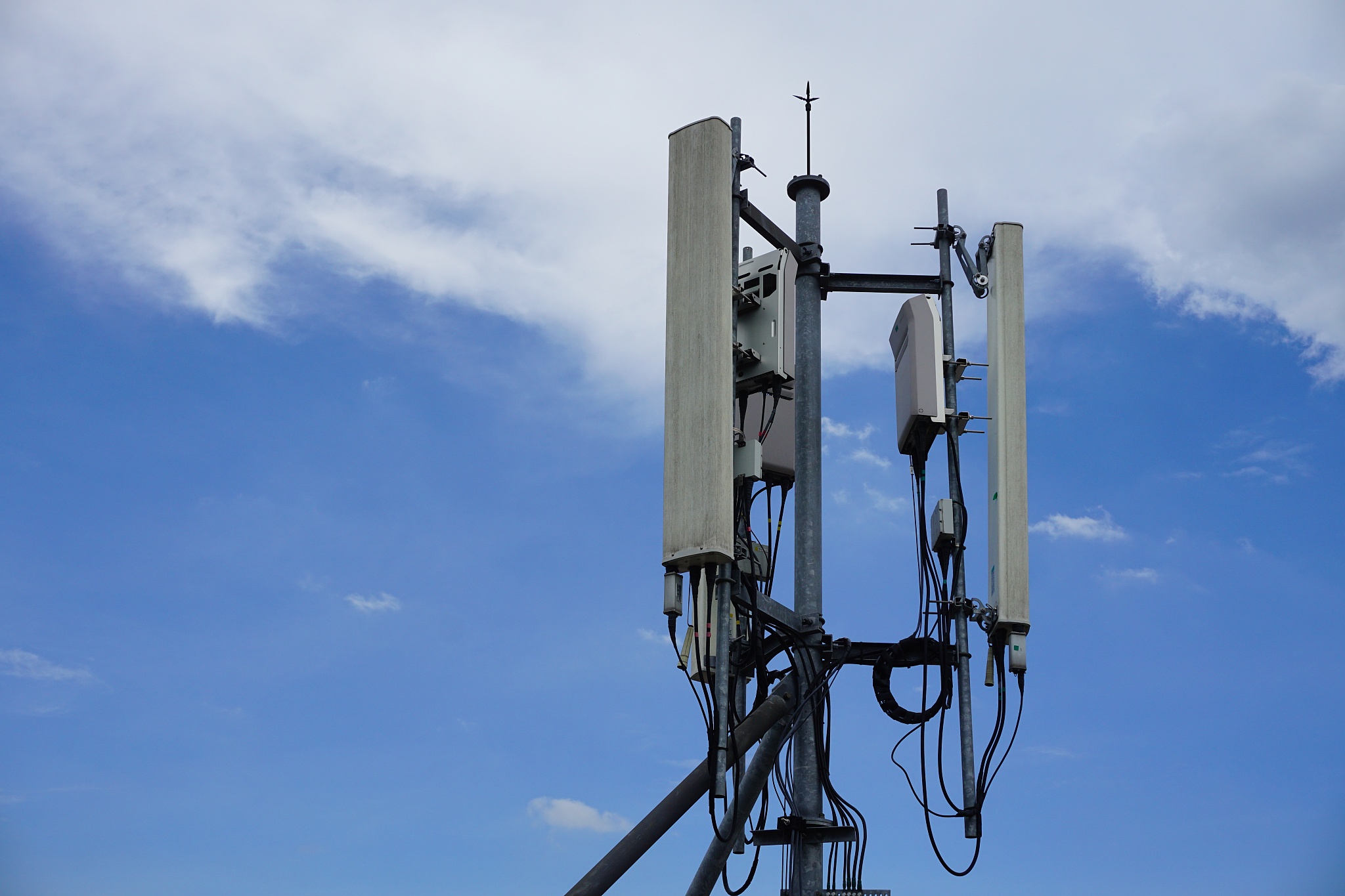 cell phone telecommunication tower with clouds,blue sky