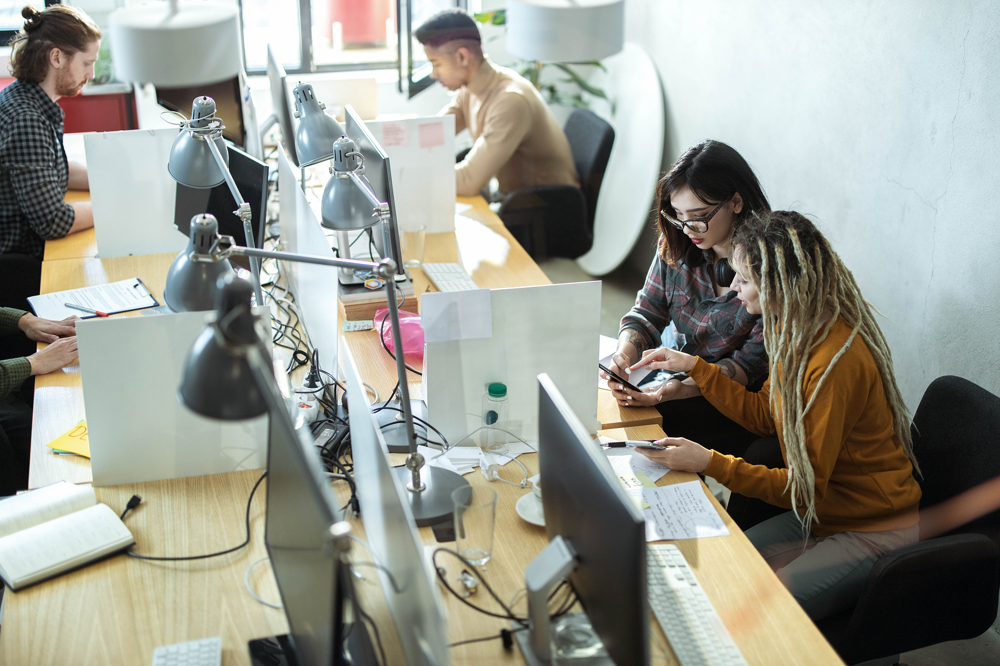 above view of young computer programmers working in the office.
