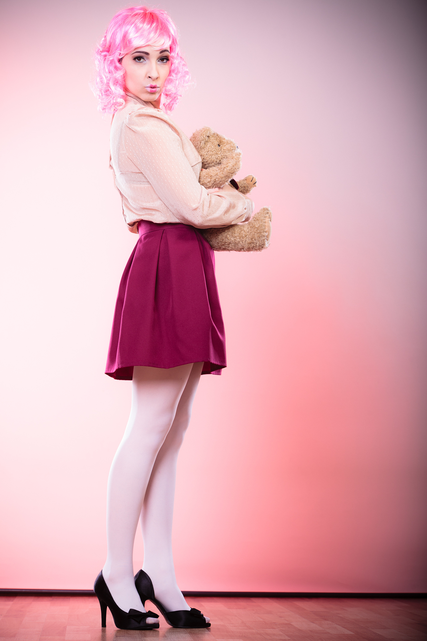 childlike woman with teddy bear toy