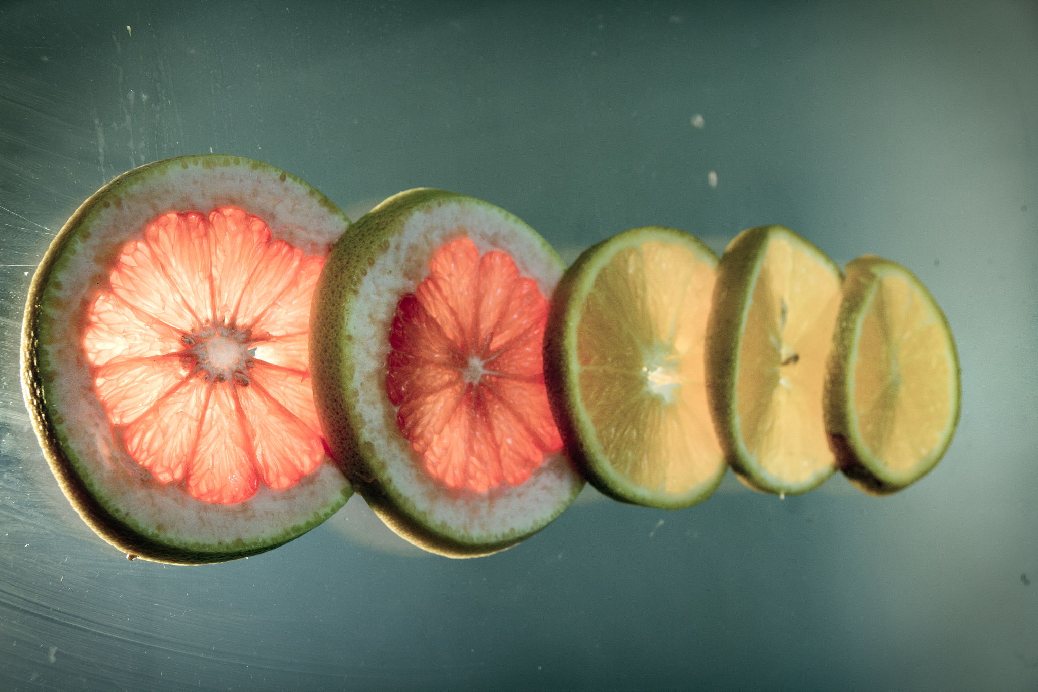 grapefruit and orange slices photograph on lighted glass