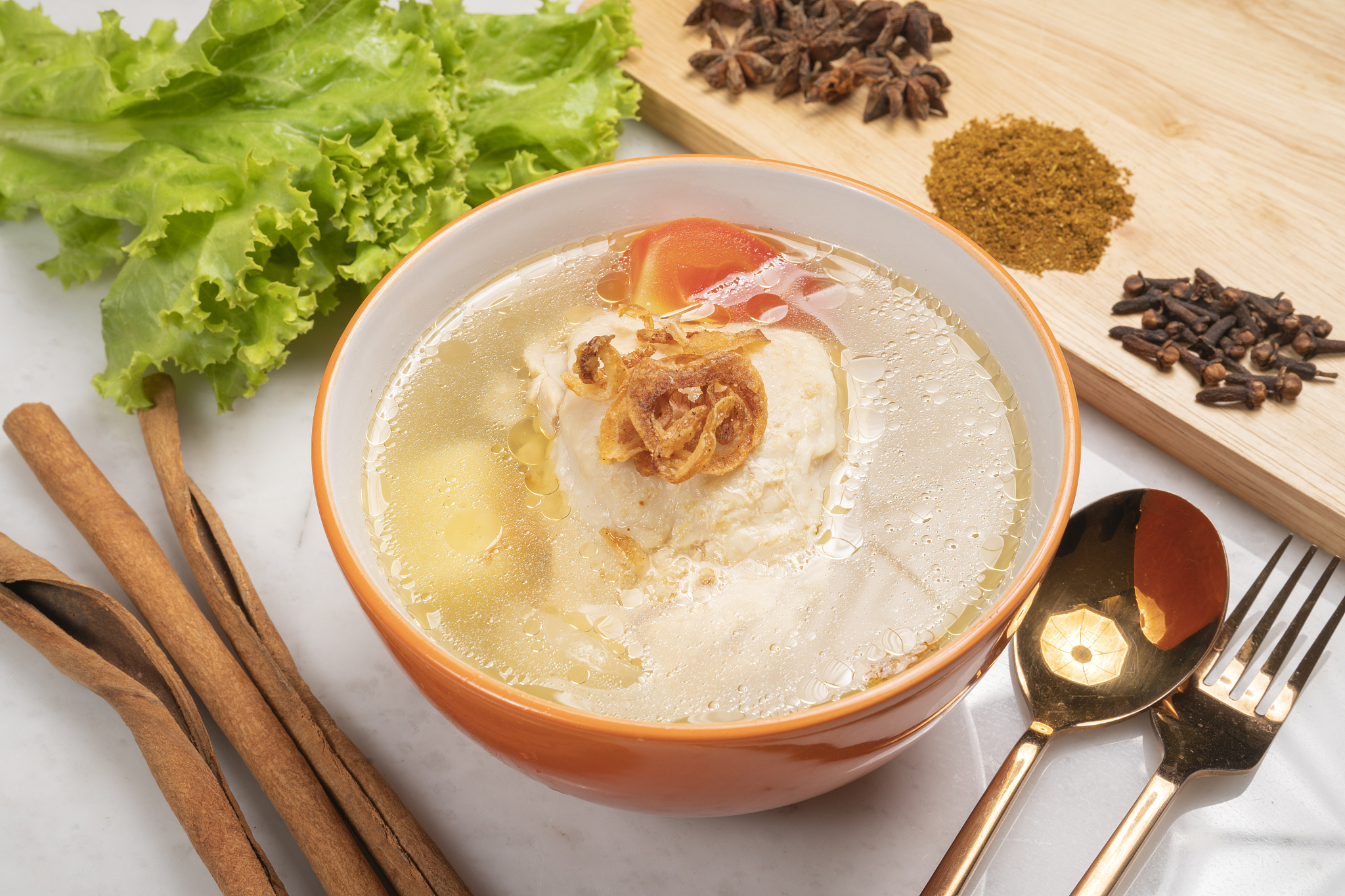 hot chicken soup with vegetables in white bowl.