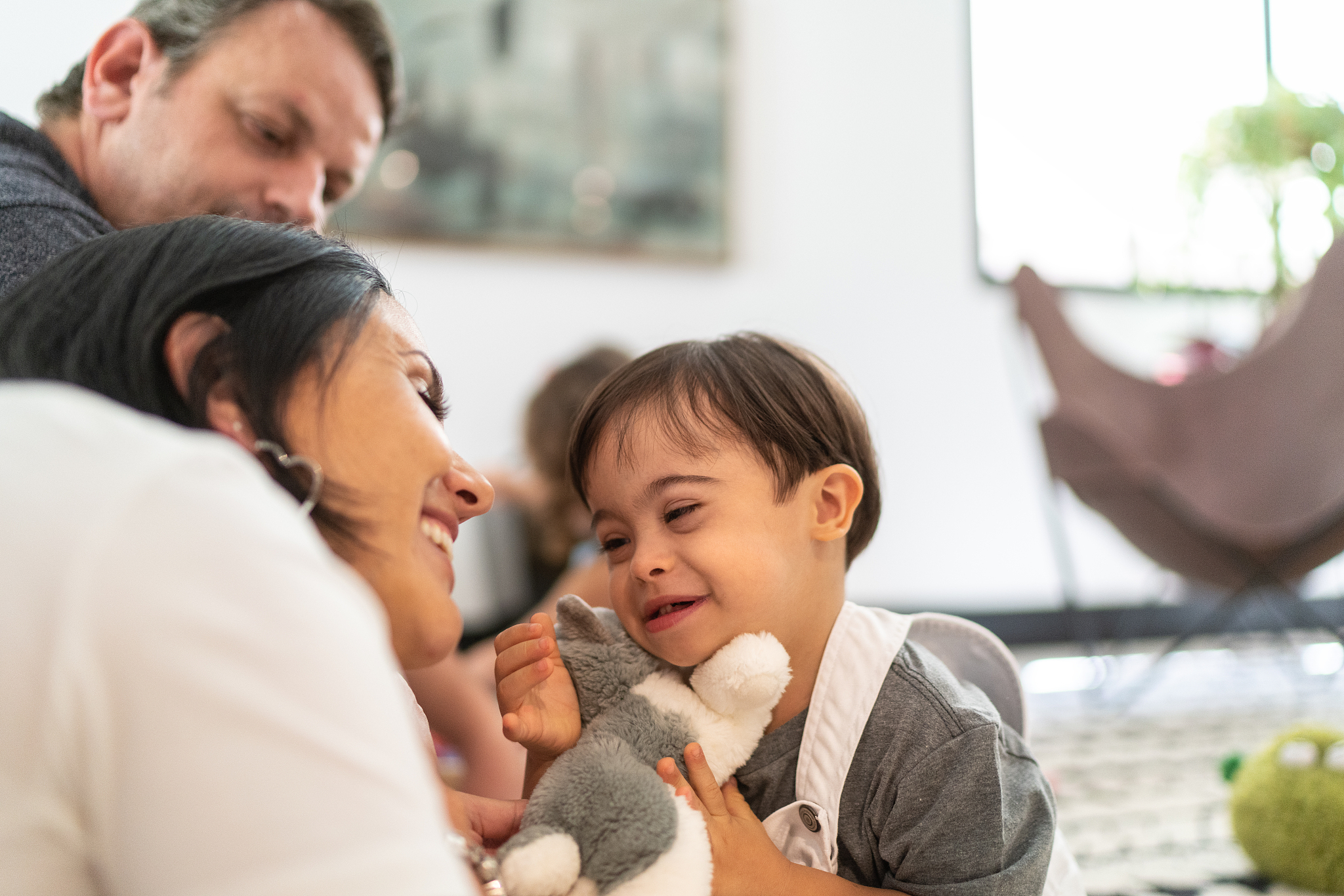 parents playing with down syndrome son