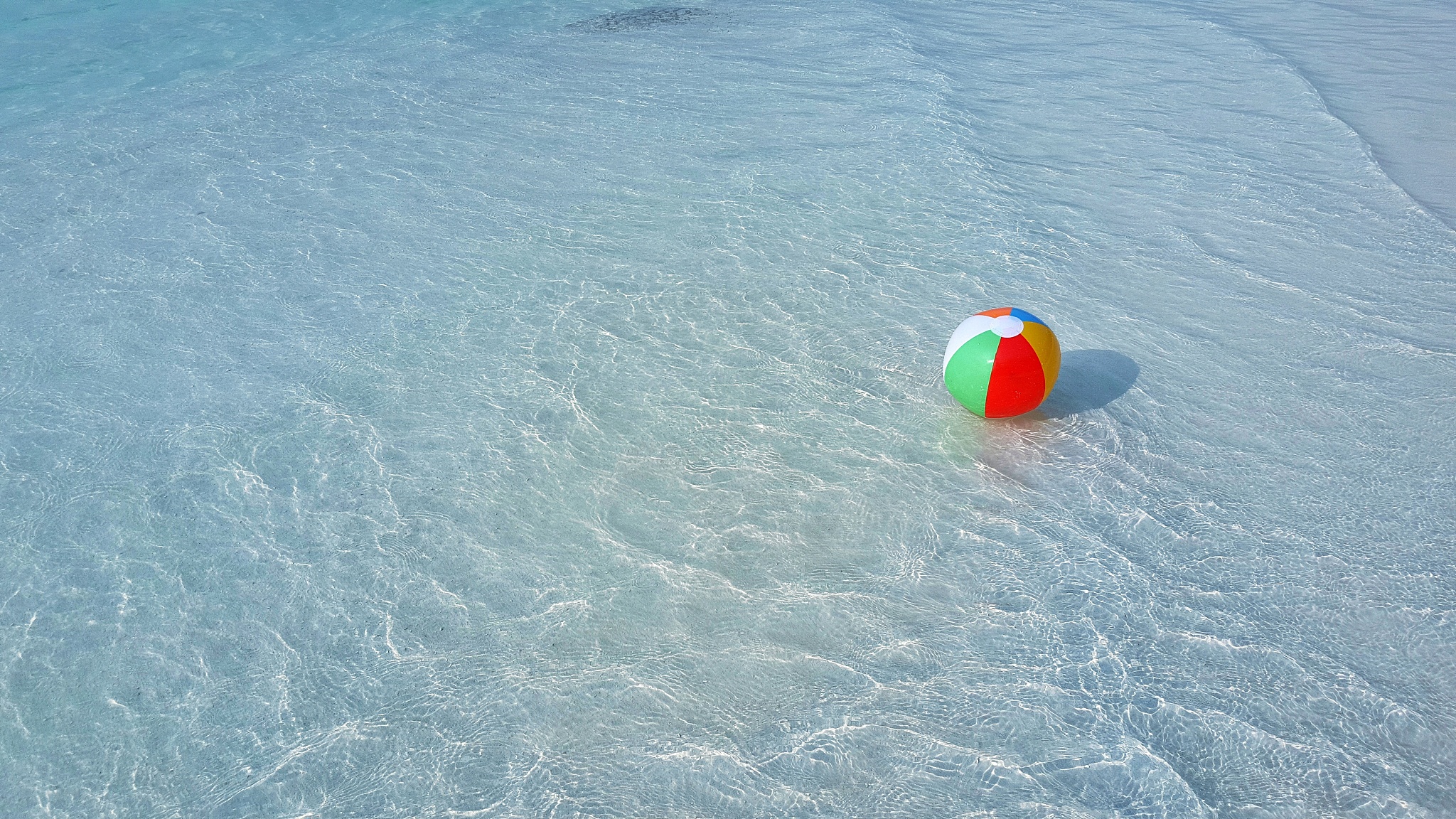 ball floating on shallow sea water in summer