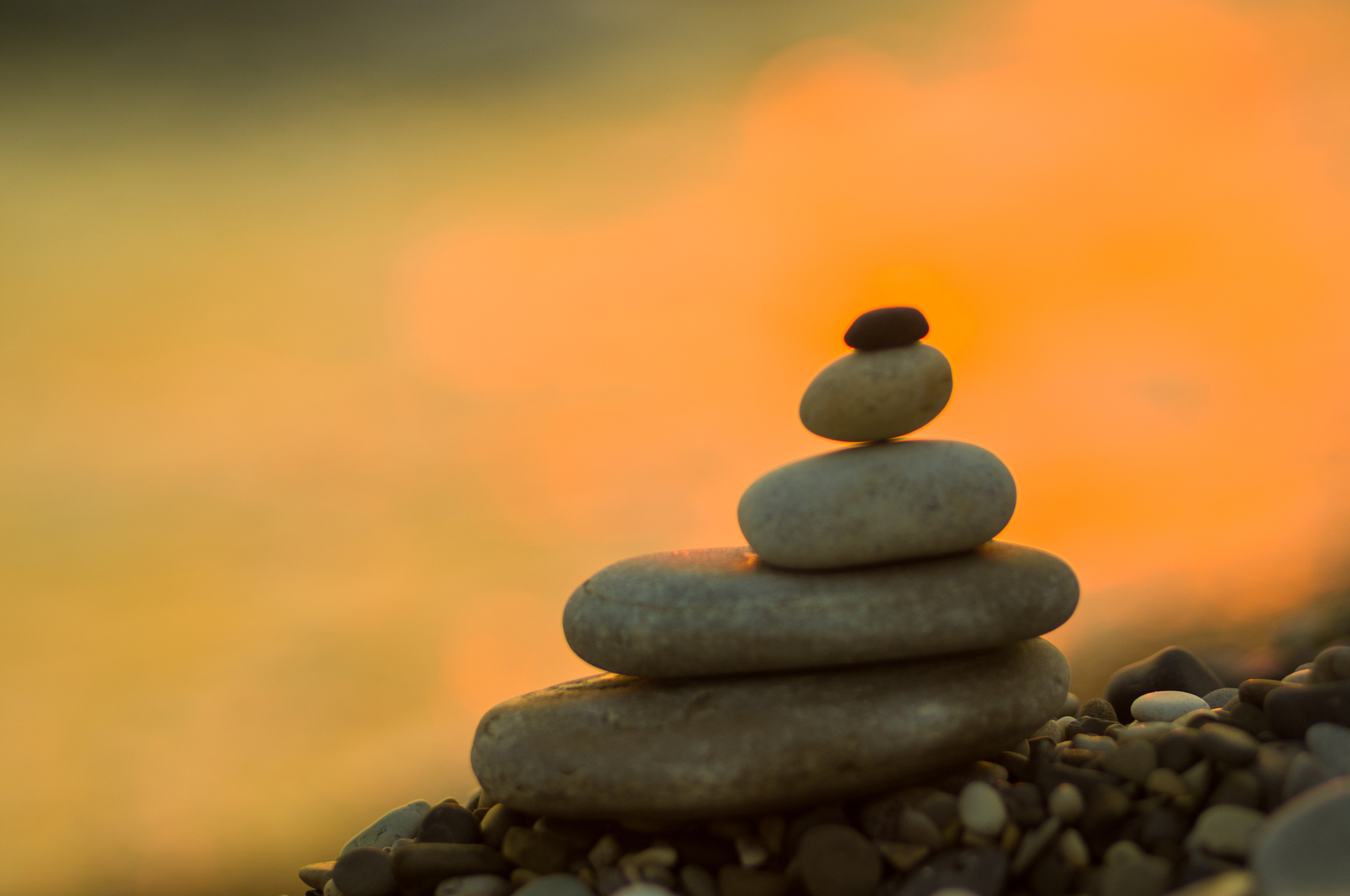 stack of zen stones on pebble beach