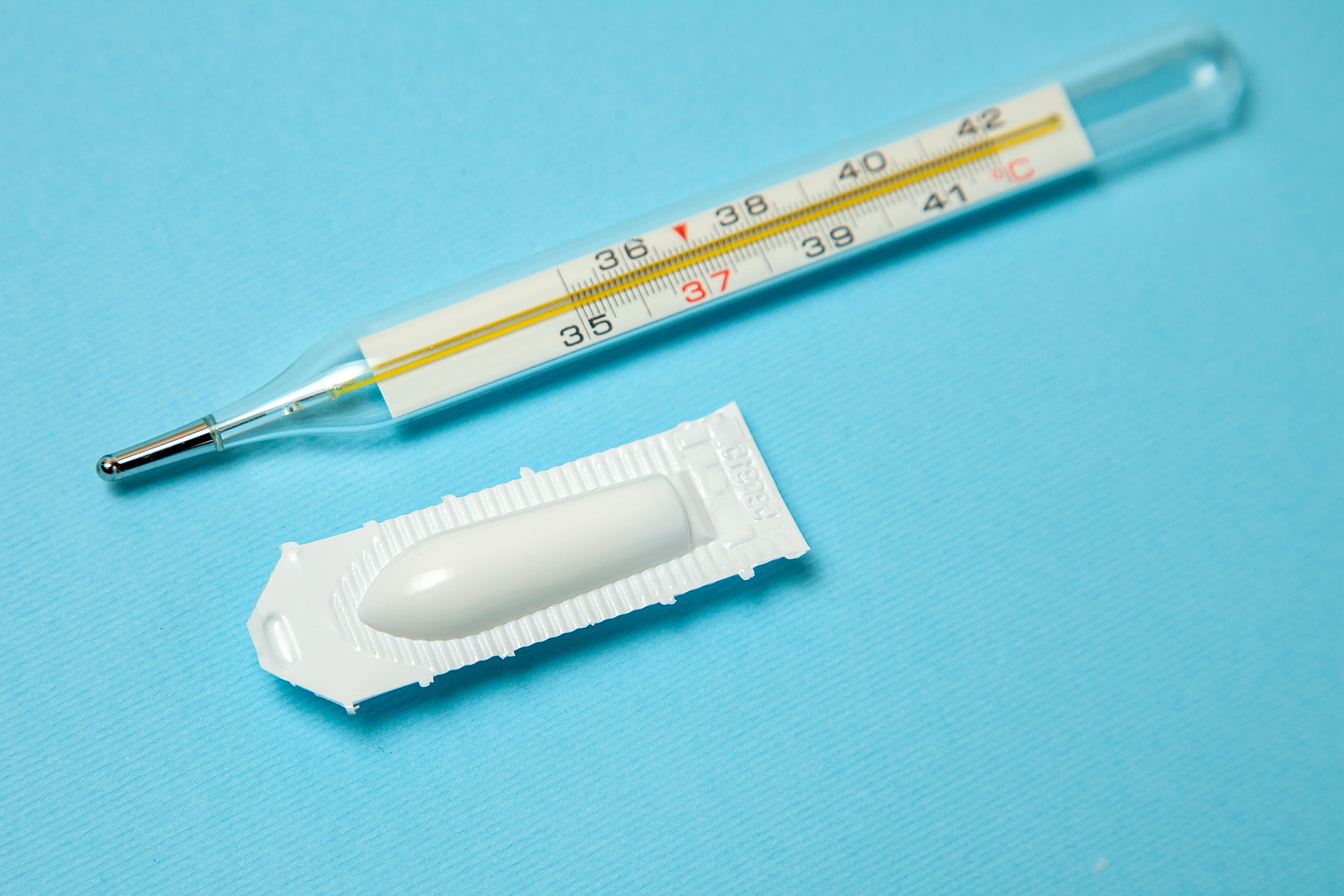 suppository for anal or vaginal use and thermometer. candles for