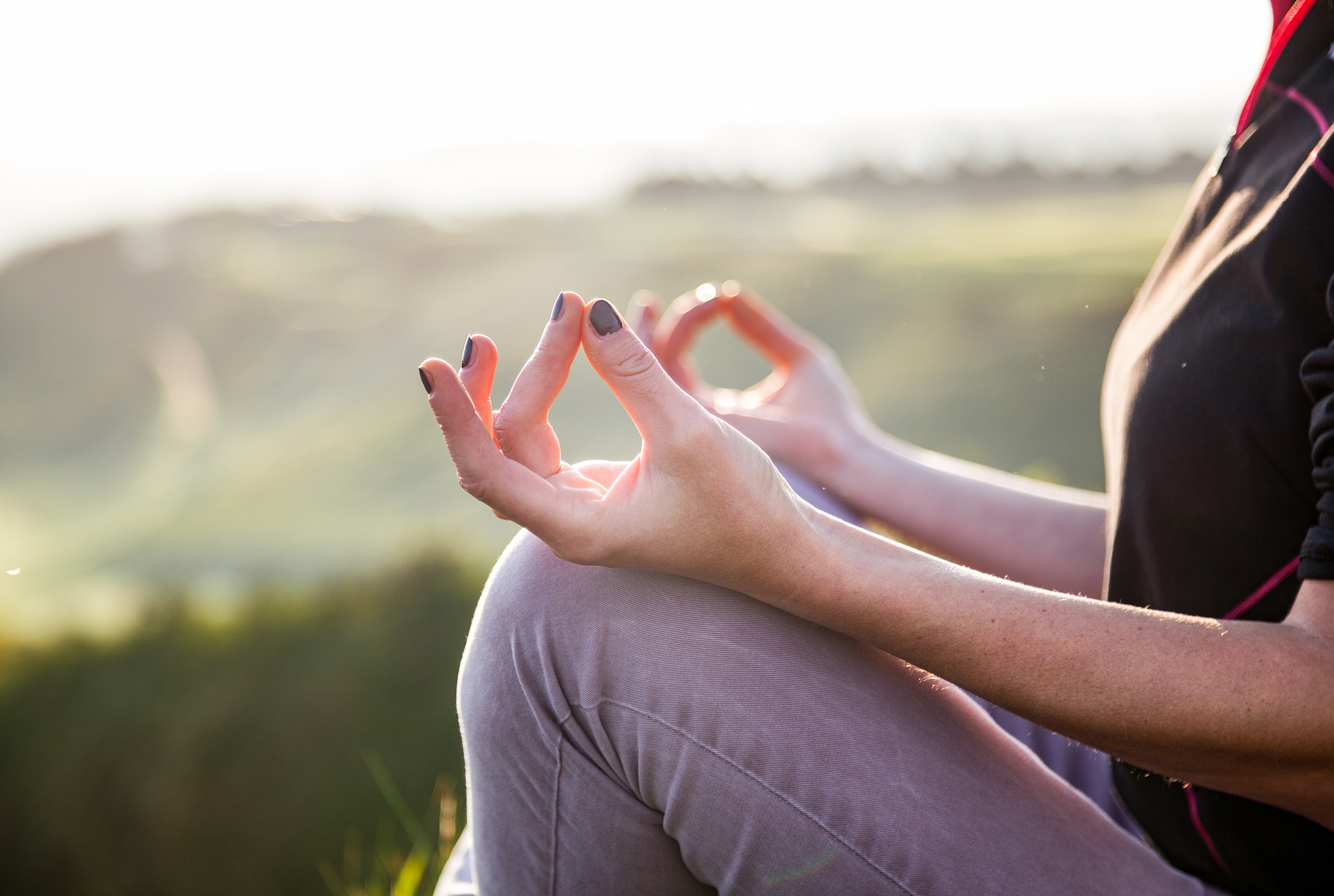 woman doing yoga in beautiful nature background at sunset or sun